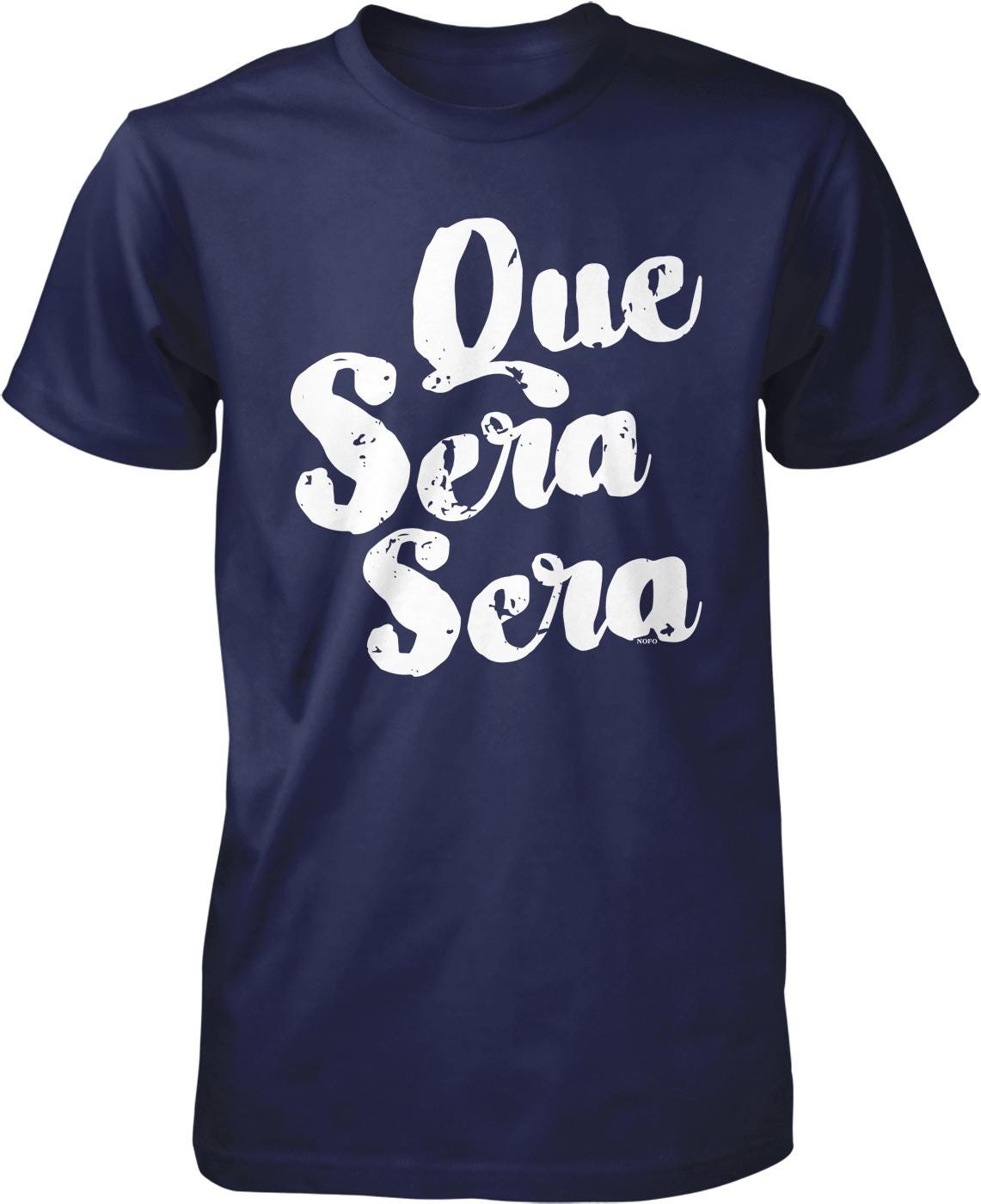 A navy blue t-shirt with white text that reads "Que sera sera" printed on it.