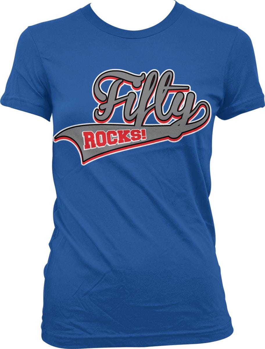 A blue t-shirt with a graphic design featuring the text "Fifty Rocks!" in a stylized font.