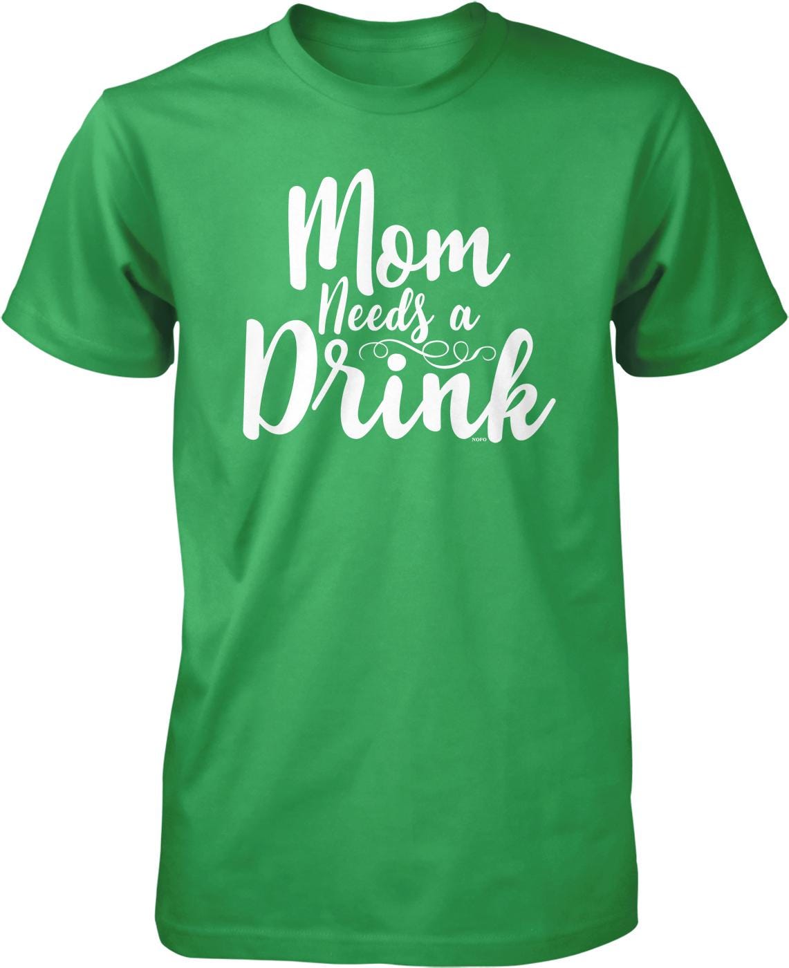 A green t-shirt with white text that says "Mom Needs a Drink".