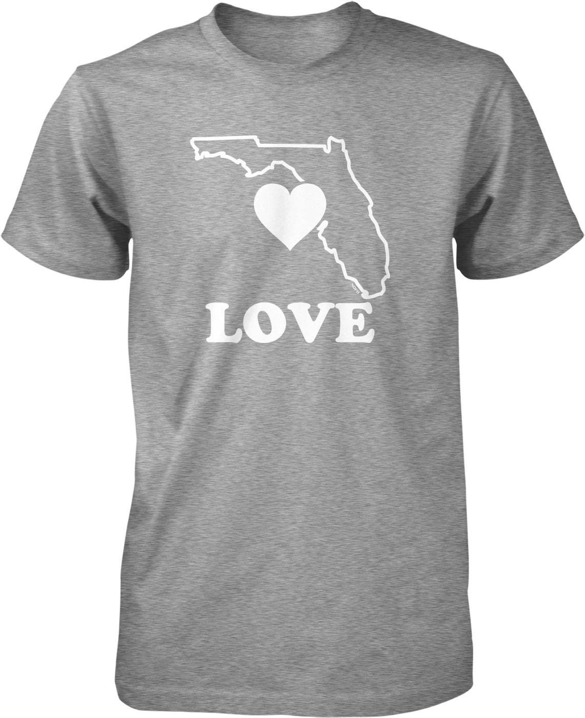A gray t-shirt with a white graphic design depicting the outline of Florida and the word "LOVE" written below it.