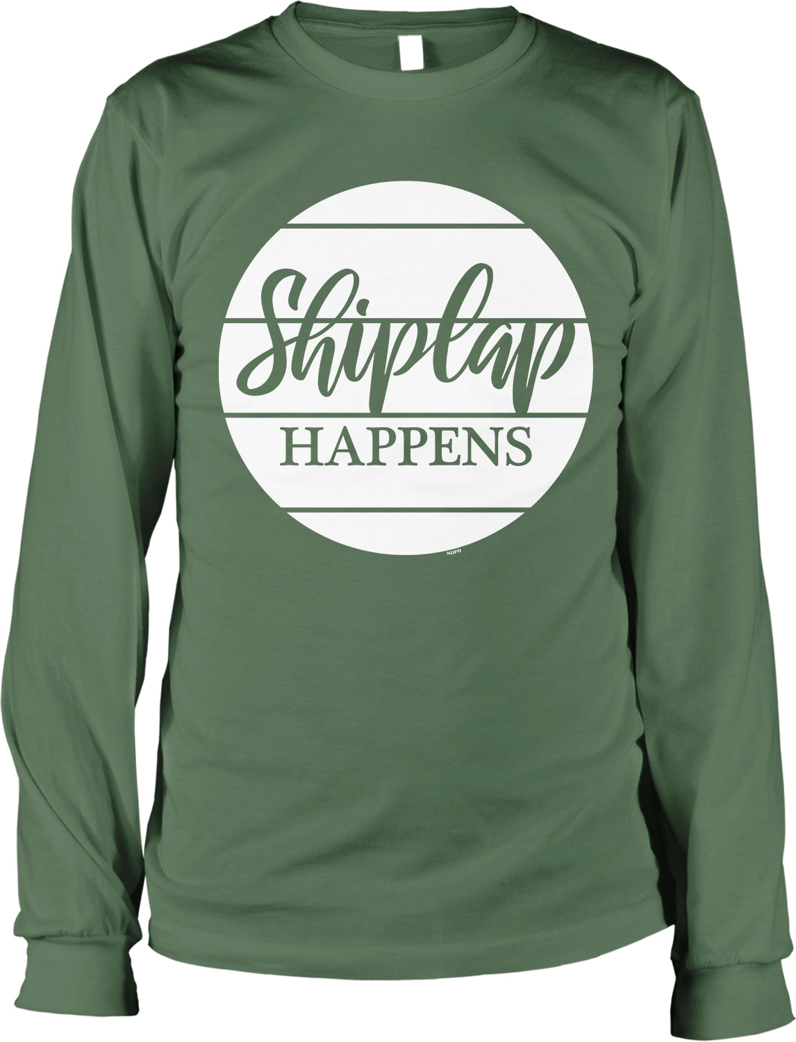 A green long-sleeved t-shirt with a white circular graphic that says "Shiplap Happens" in a stylized font.