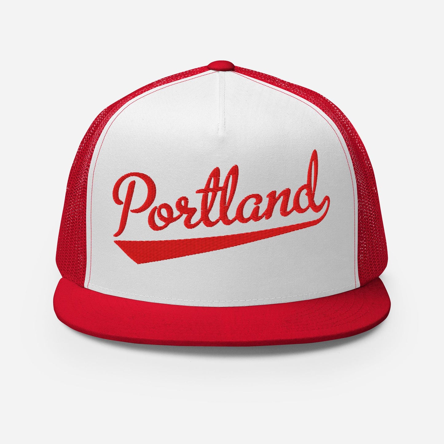 A red and white baseball cap with the word "Portland" printed on it.
