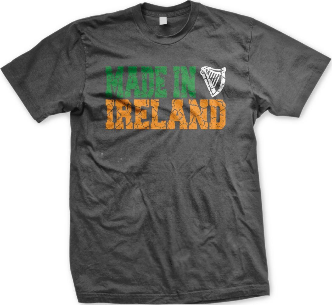 A gray t-shirt with the text "MADE IN IRELAND" printed on it in orange and green colors.