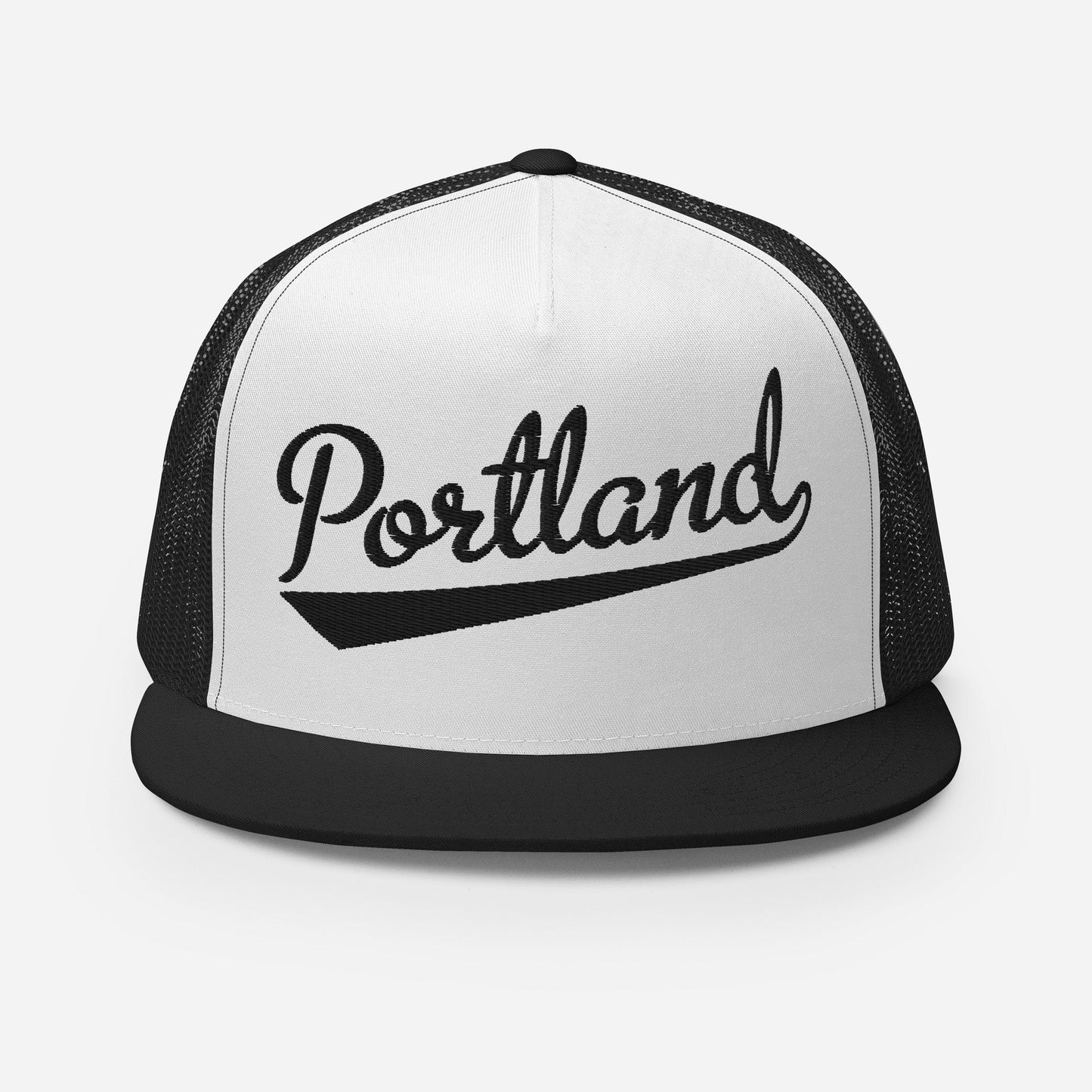 A black and white baseball cap with the word "Portland" printed on it.