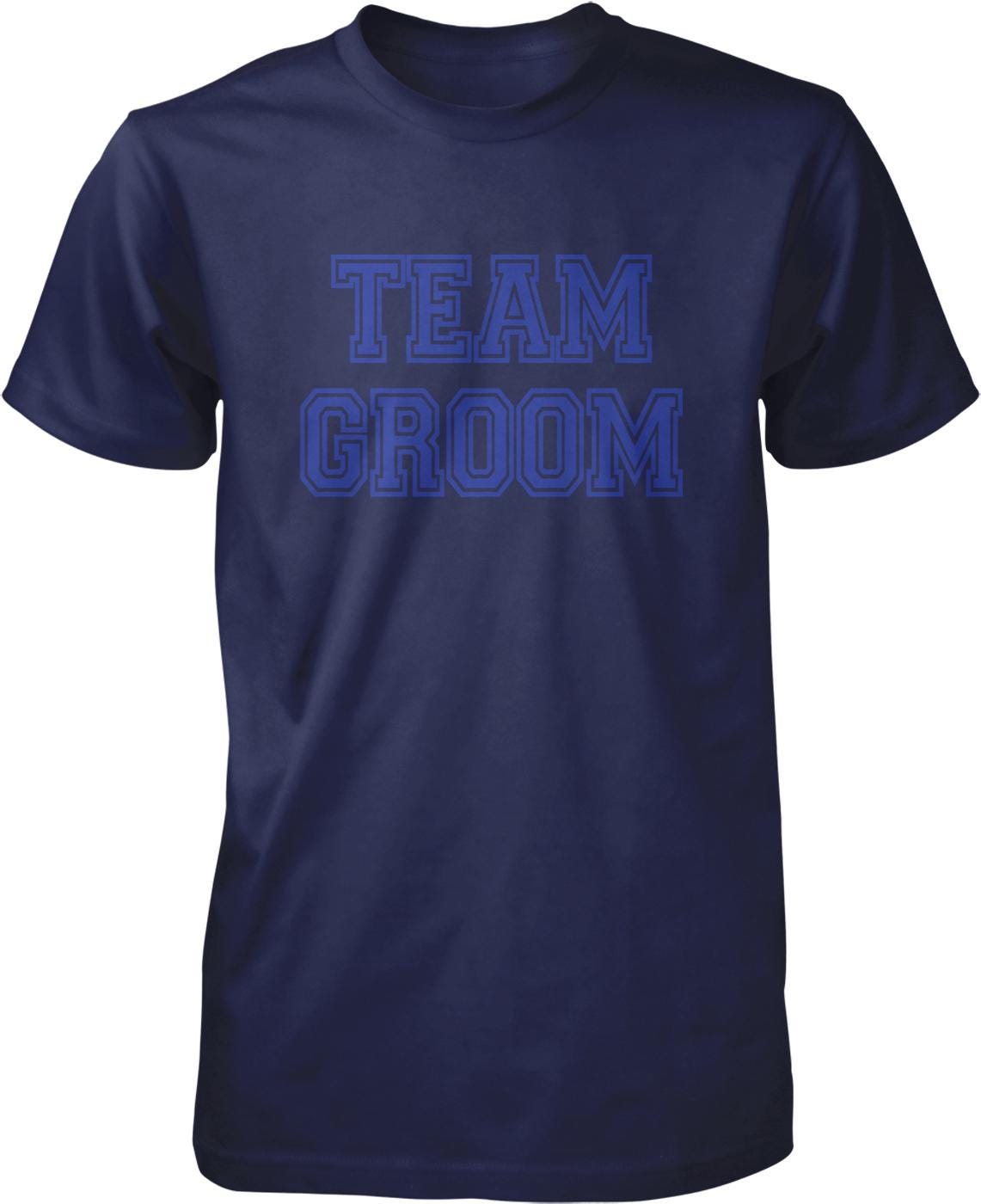 A navy blue t-shirt with the text "TEAM GROOM" printed in blue letters.
