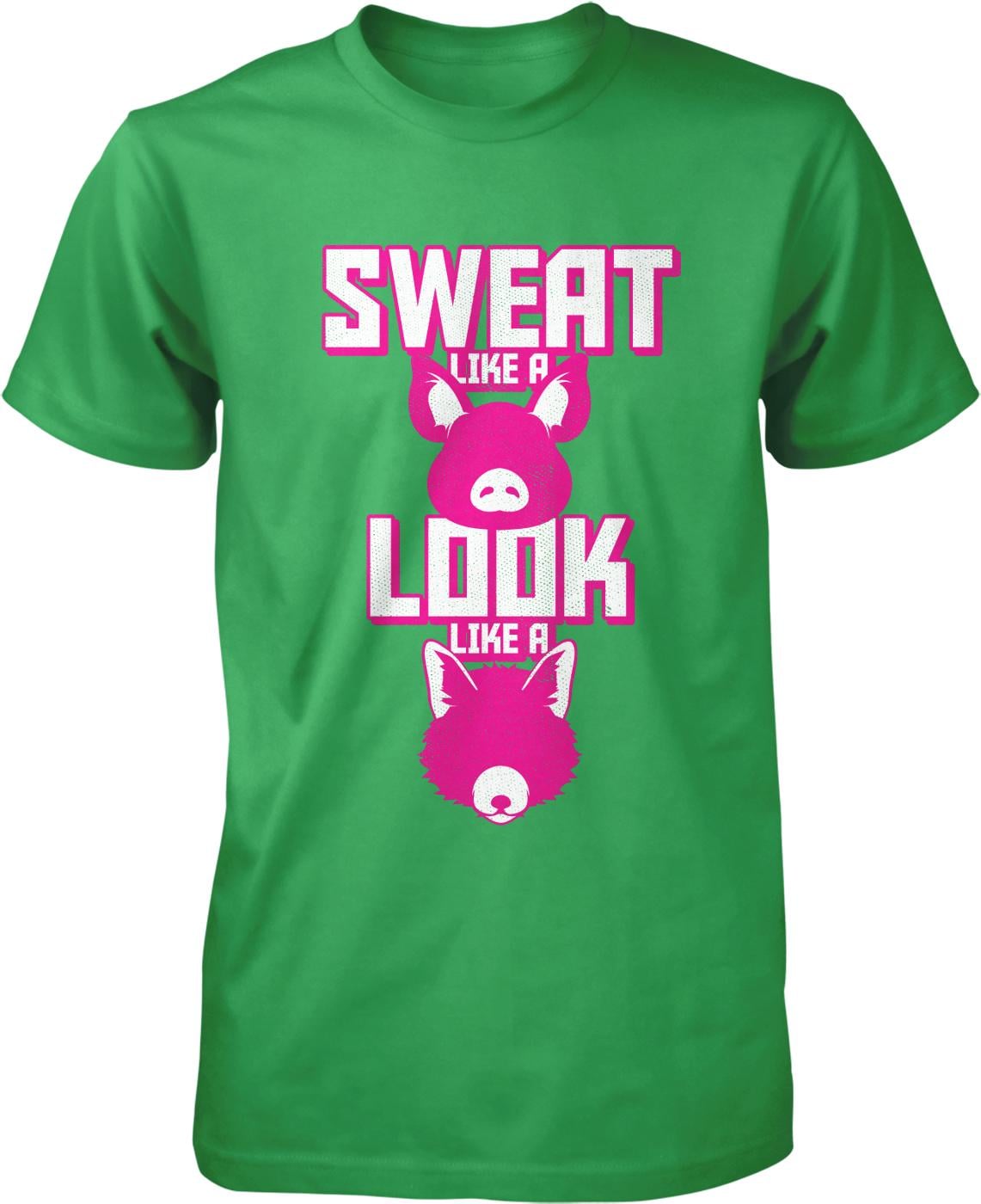 A green t-shirt with a graphic design featuring a pink pig and the text "SWEAT LIKE A LOOK LIKE A" printed on it.