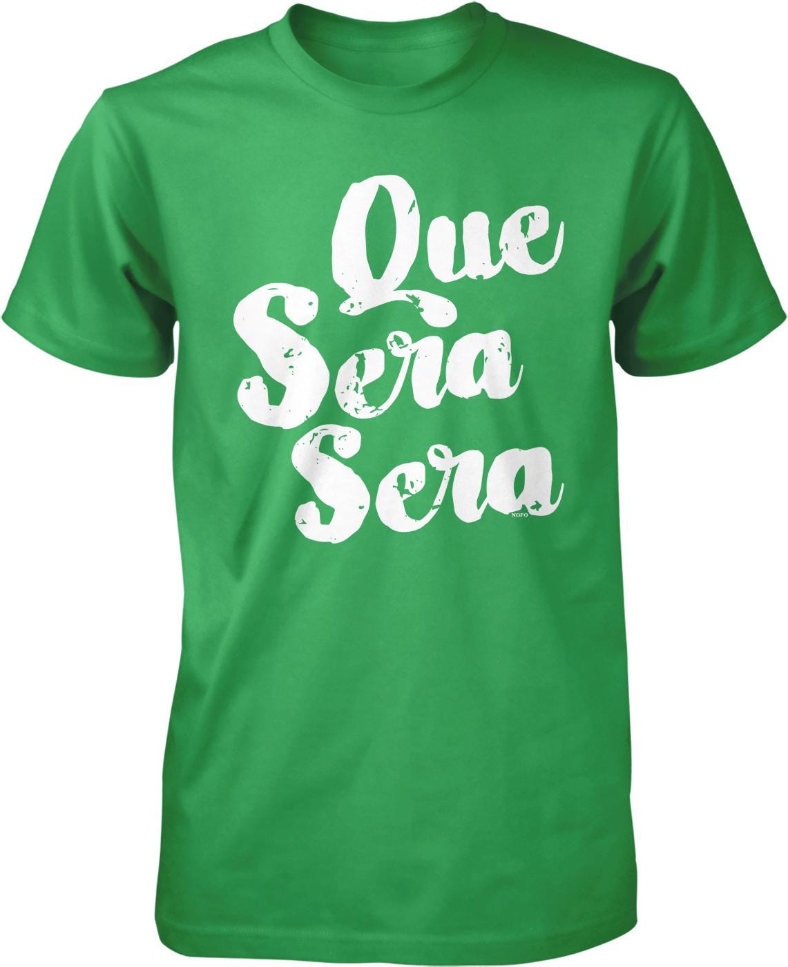 A green t-shirt with white text that says "Que sera sera" printed on it.