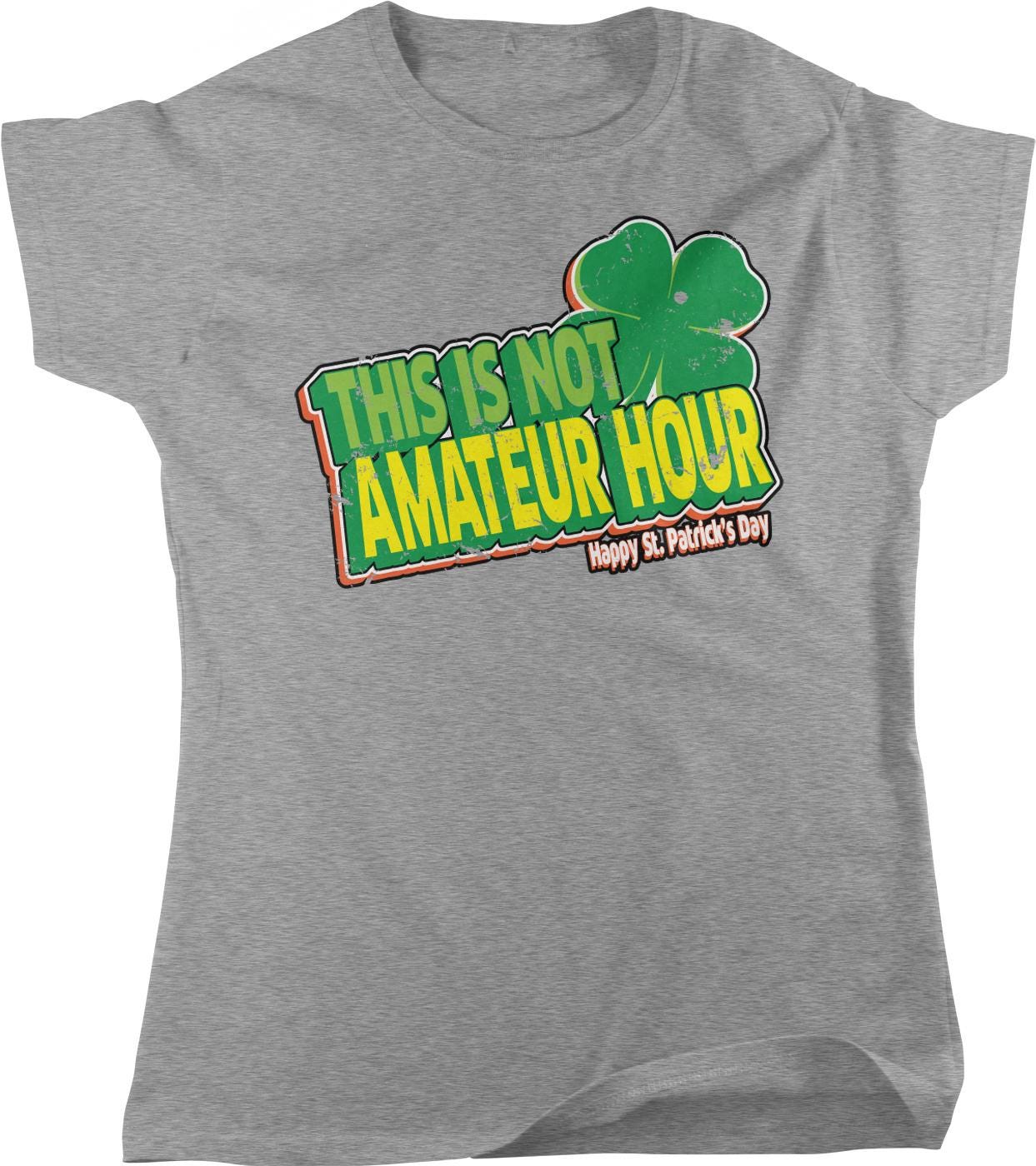A gray t-shirt with a graphic design featuring a cloverleaf and text that reads "This is not amateur hour Happy St. Patrick's Day".