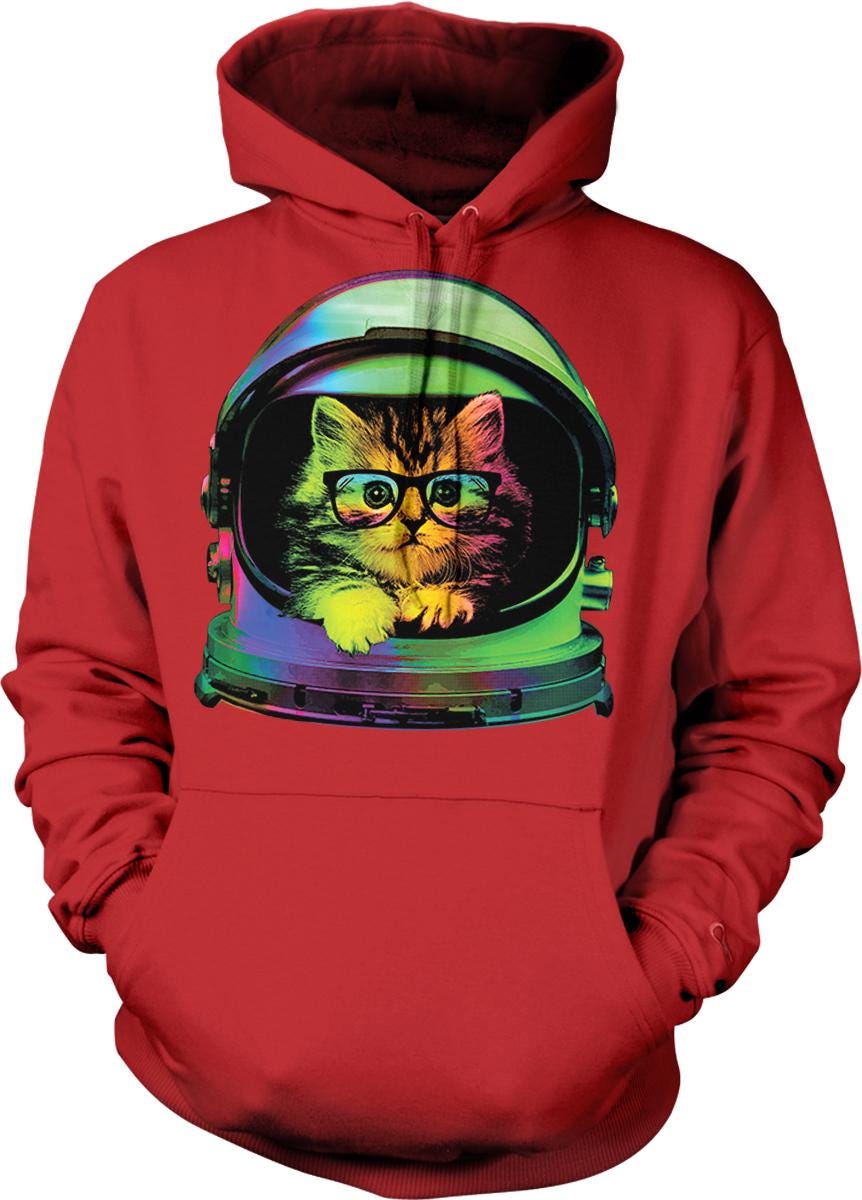 A red hoodie with a graphic of a cat wearing a green and purple helmet, with a pair of glasses on its face.