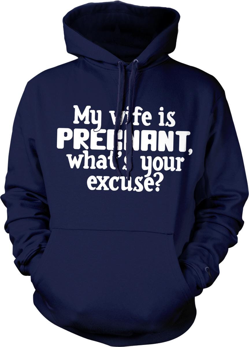 A navy blue hoodie with white text that reads "My wife is pregnant, what's your excuse?"