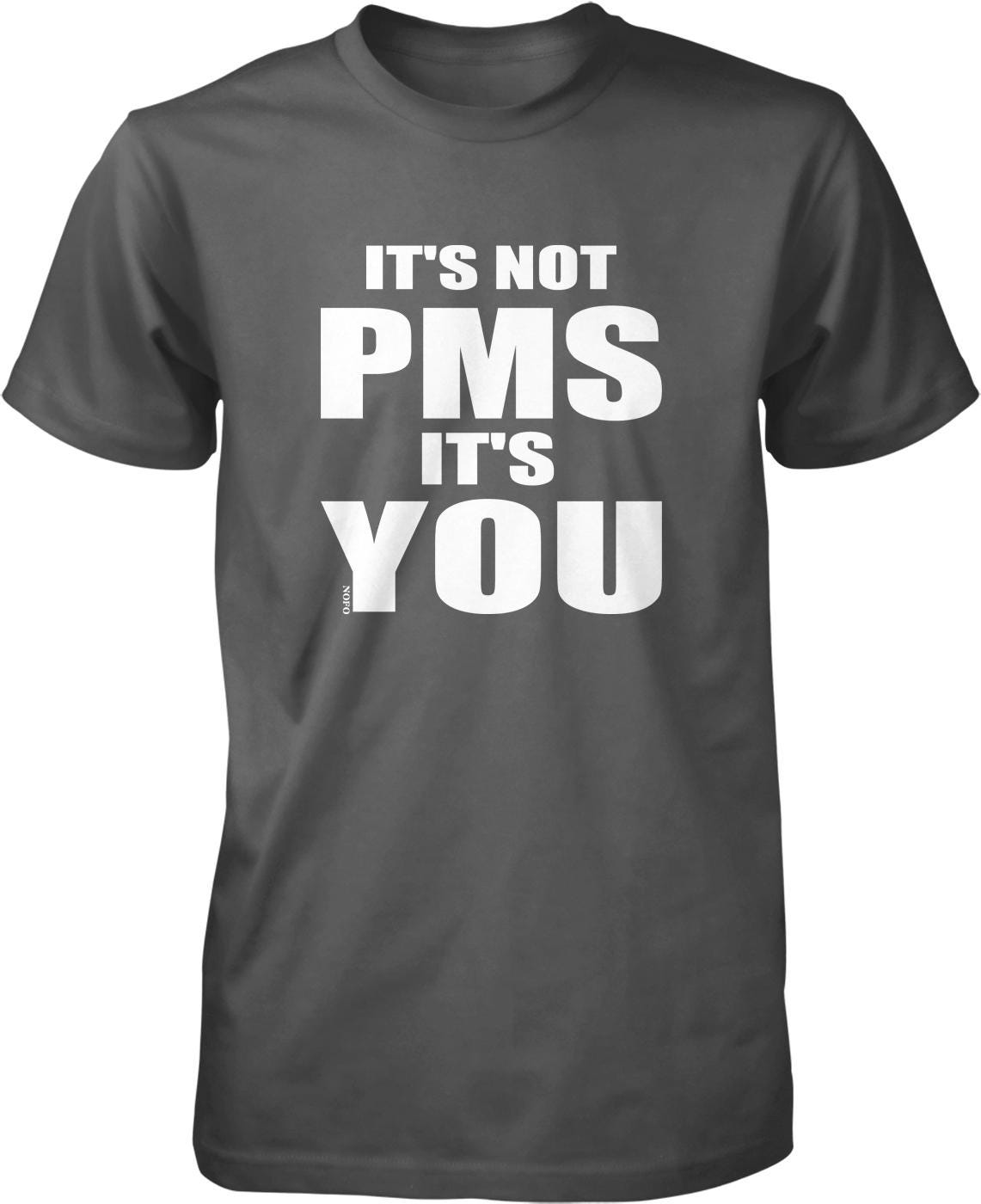 A black t-shirt with white text that reads "IT'S NOT PMS IT'S YOU".