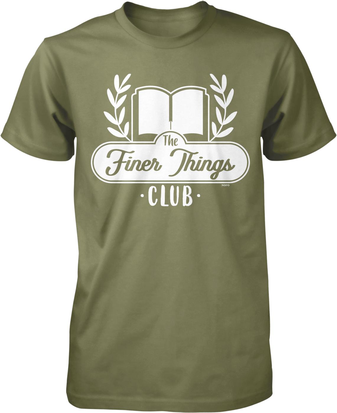A green t-shirt with a white graphic design featuring a book and laurel wreath, along with the text "The Finer Things Club" printed on it.