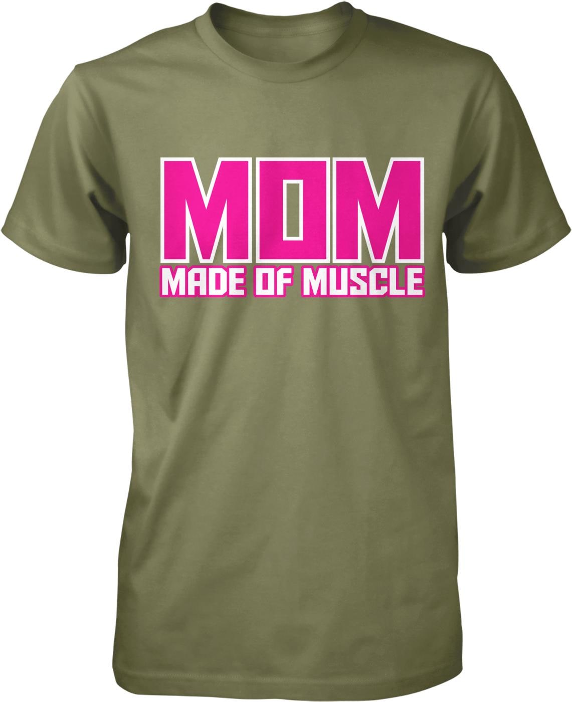 A green t-shirt with the text "MOM MADE OF MUSCLE" printed in pink and white letters.
