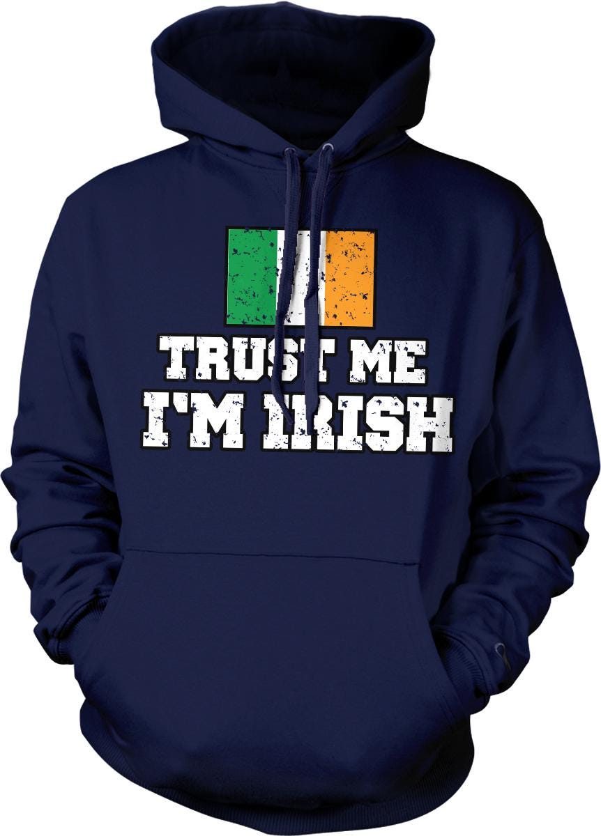 A navy blue hoodie with a graphic design featuring the text "TRUST ME I'M IRISH" and an Irish flag.