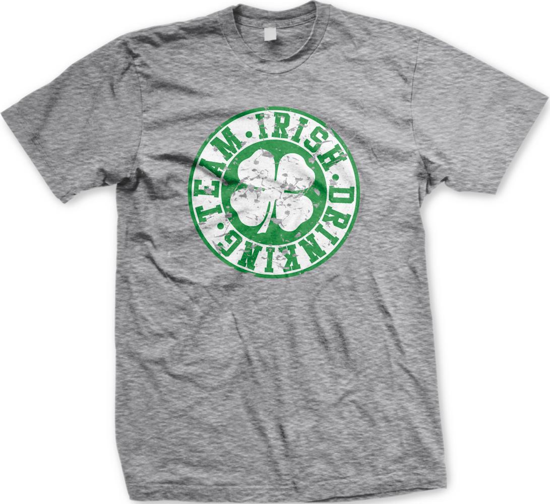 A gray t-shirt with a green circular logo featuring a white clover and the text "TEAM. IRISH. DRINKING" printed on it.