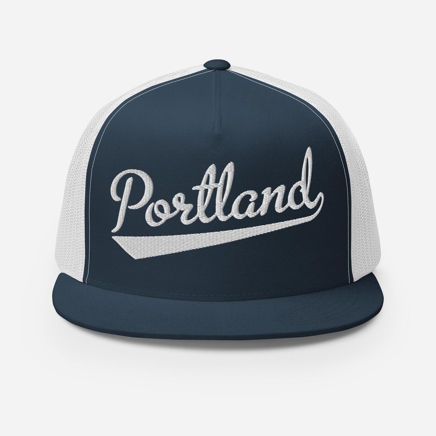 A navy blue and white baseball cap with the word "Portland" printed on it.