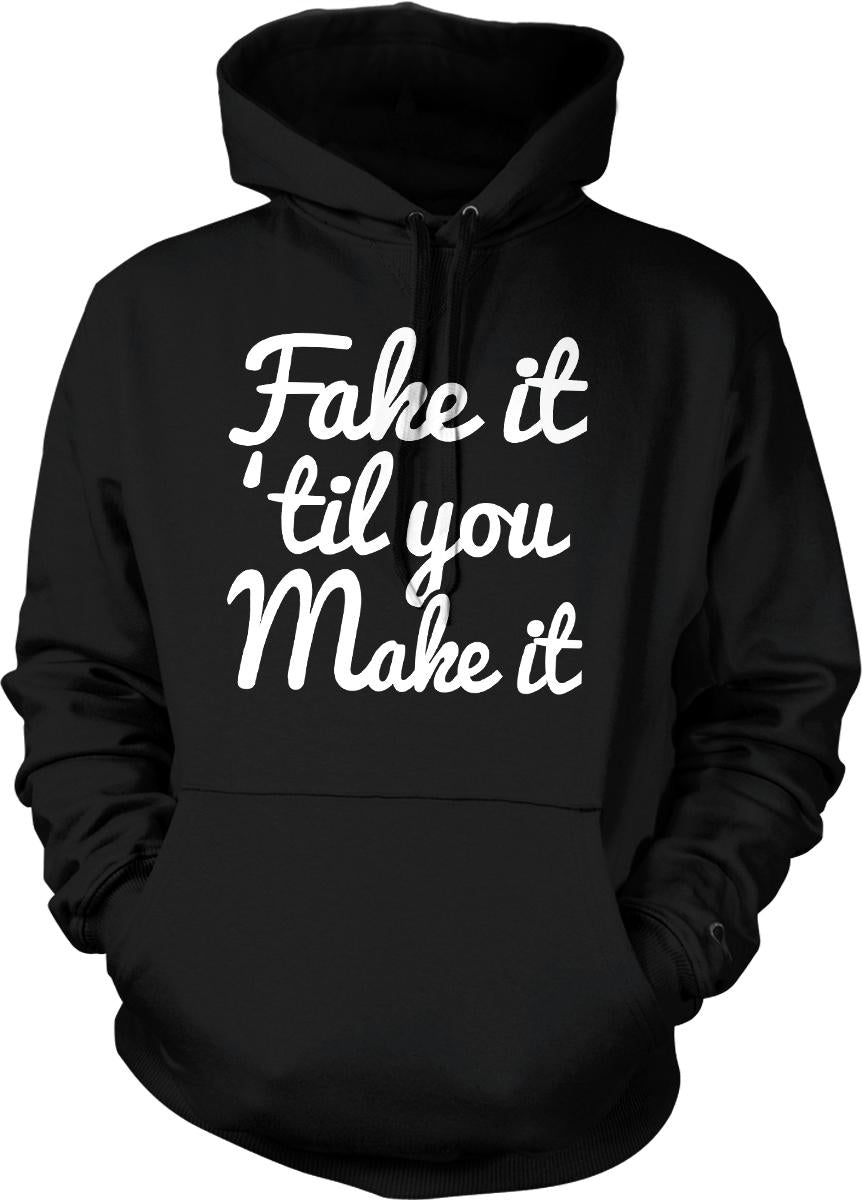 A black hoodie with white text that reads "Fake it 'til you Make it".