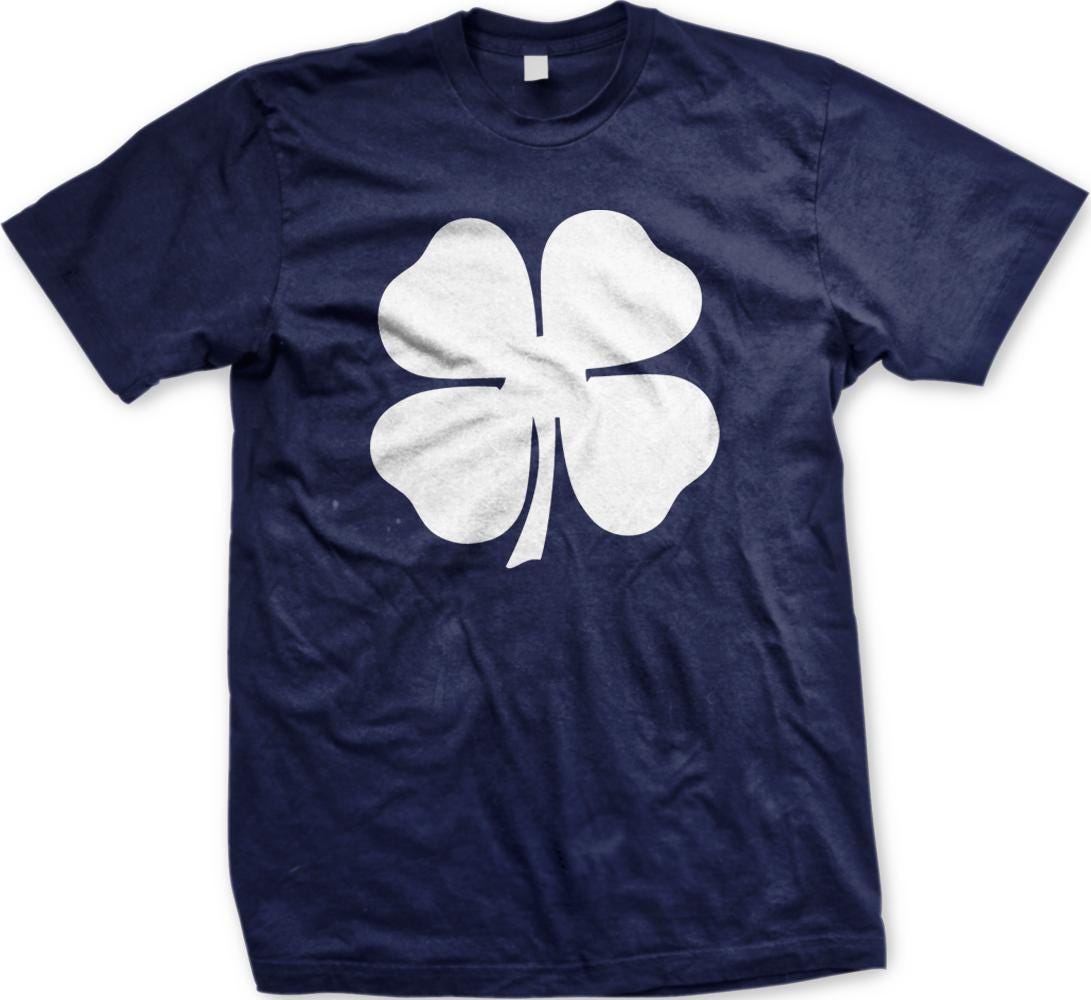 A navy blue t-shirt with a white four-leaf clover graphic printed on it.
