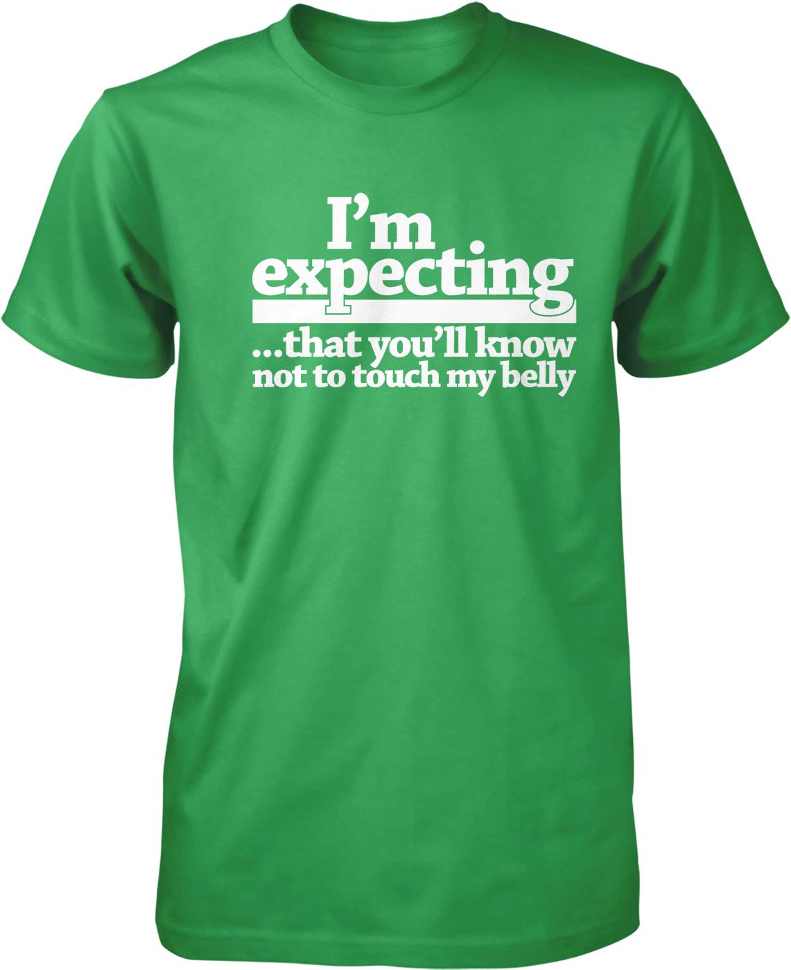 A green t-shirt with white text that reads "I'm expecting... that you'll know not to touch my belly".