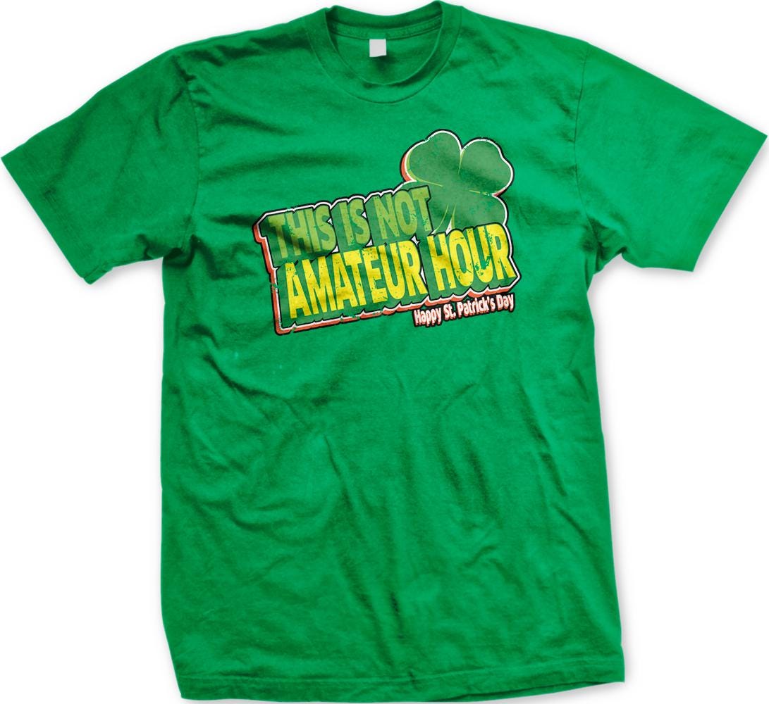 A green t-shirt with a graphic design featuring a clover and text that reads "This is not amateur hour" and "Happy St. Patrick's Day".