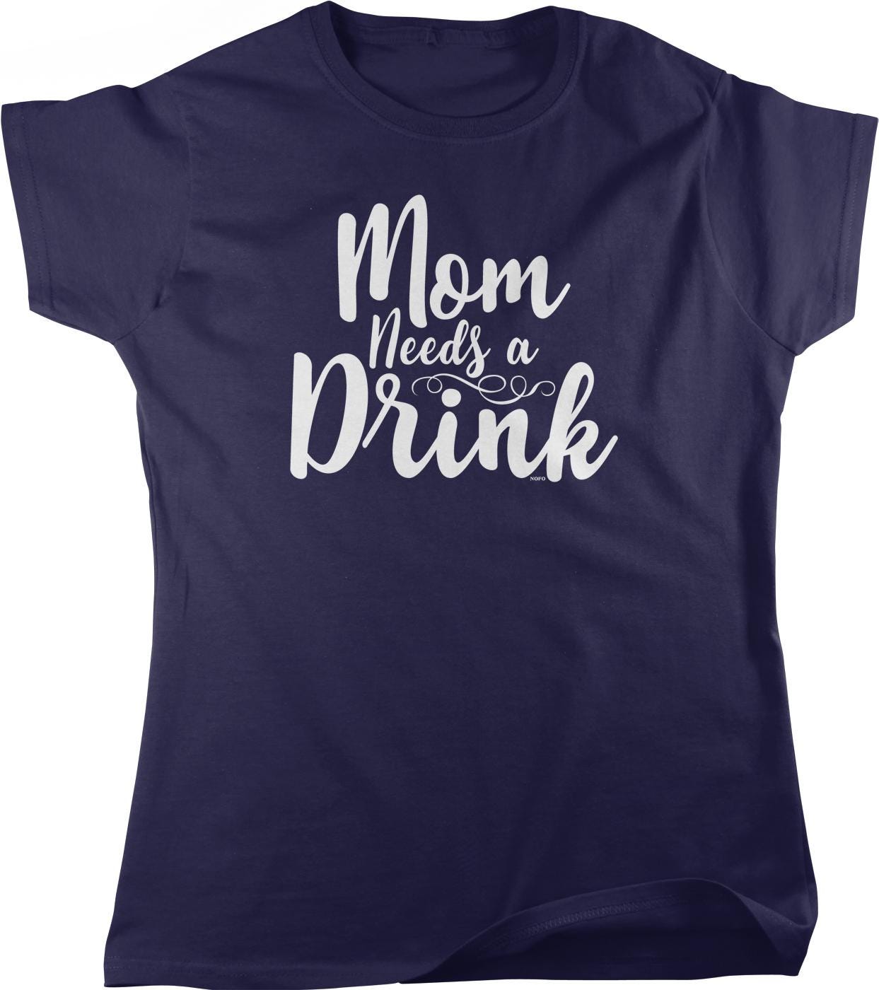 A navy blue t-shirt with the text "Mom Needs a Drink" printed on it in white lettering.