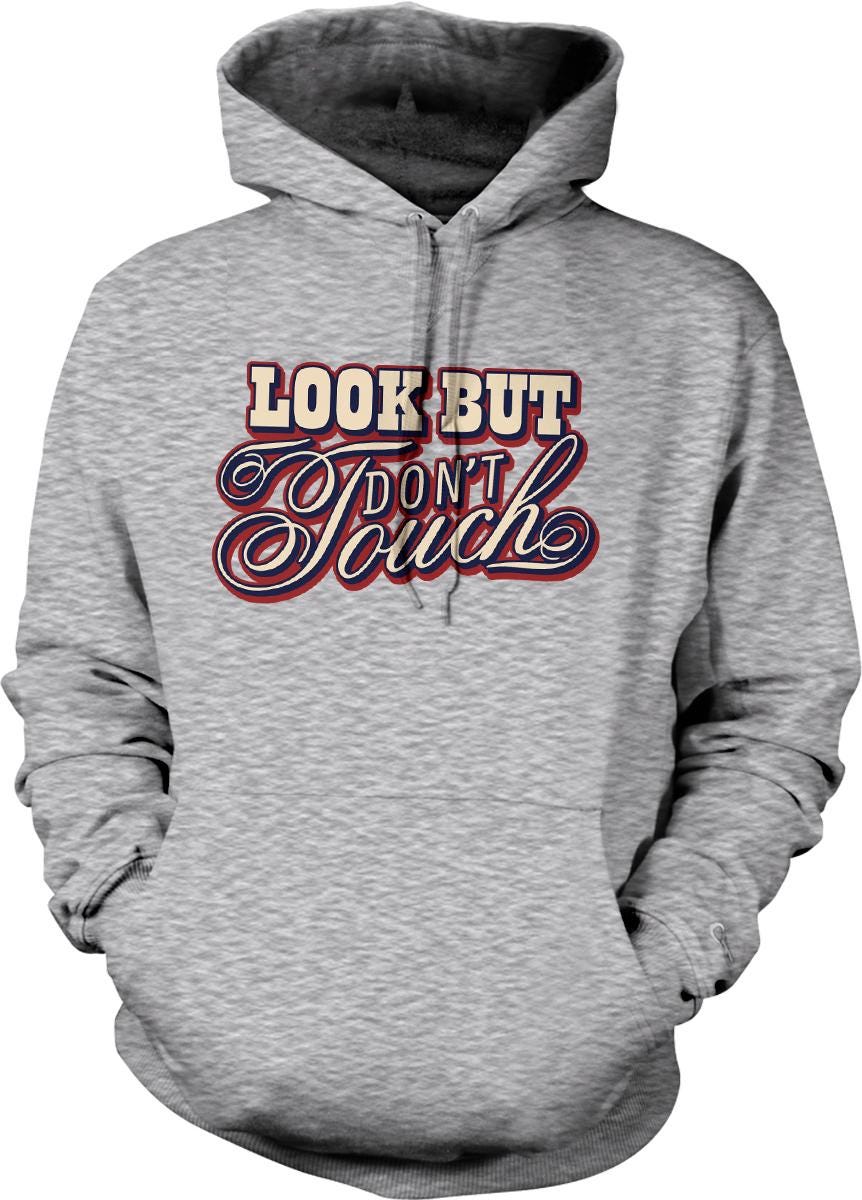 A gray hoodie with a graphic design on the front that says "Look But Don't Touch".
