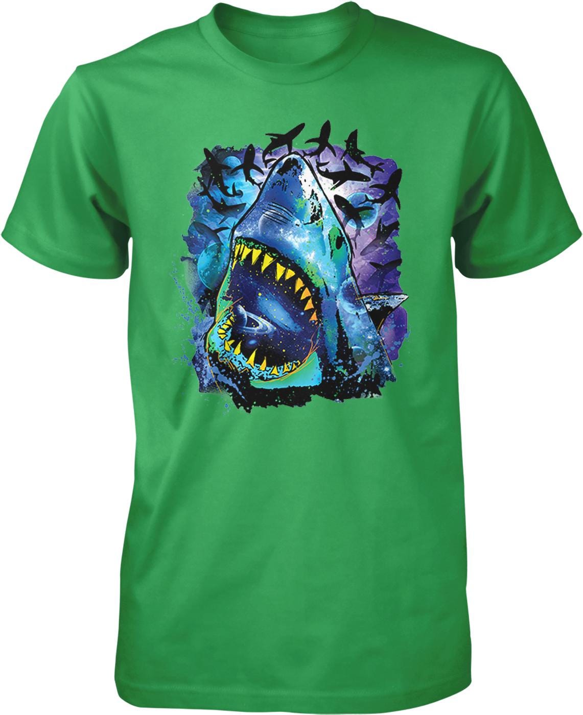 A green t-shirt with a graphic design depicting a large, open-mouthed shark surrounded by colorful, abstract elements.