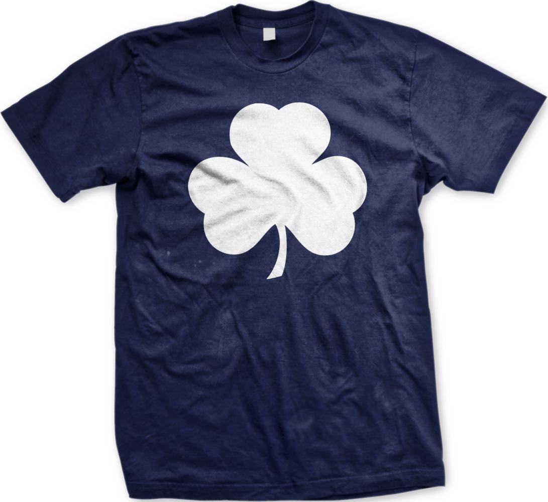 A navy blue t-shirt with a white clover graphic printed on it.