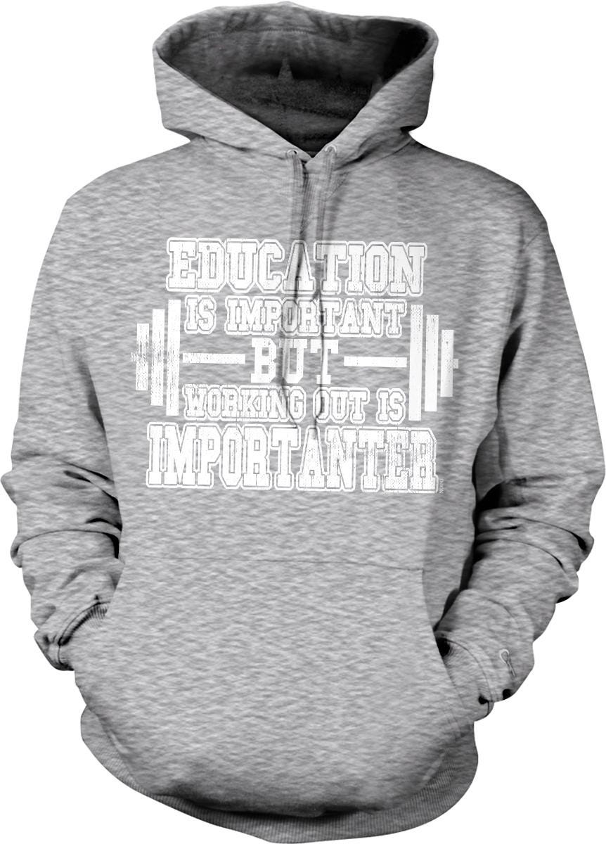 A gray hoodie with white text printed on it.