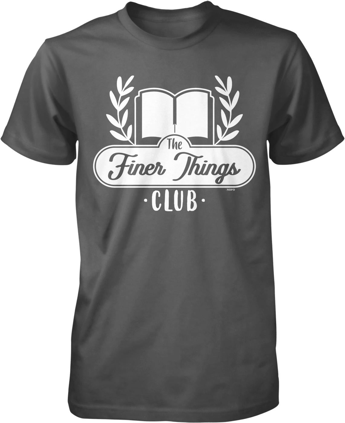 A gray t-shirt with a graphic design featuring a book and laurel wreath, along with the text "The Finer Things Club" printed on it.