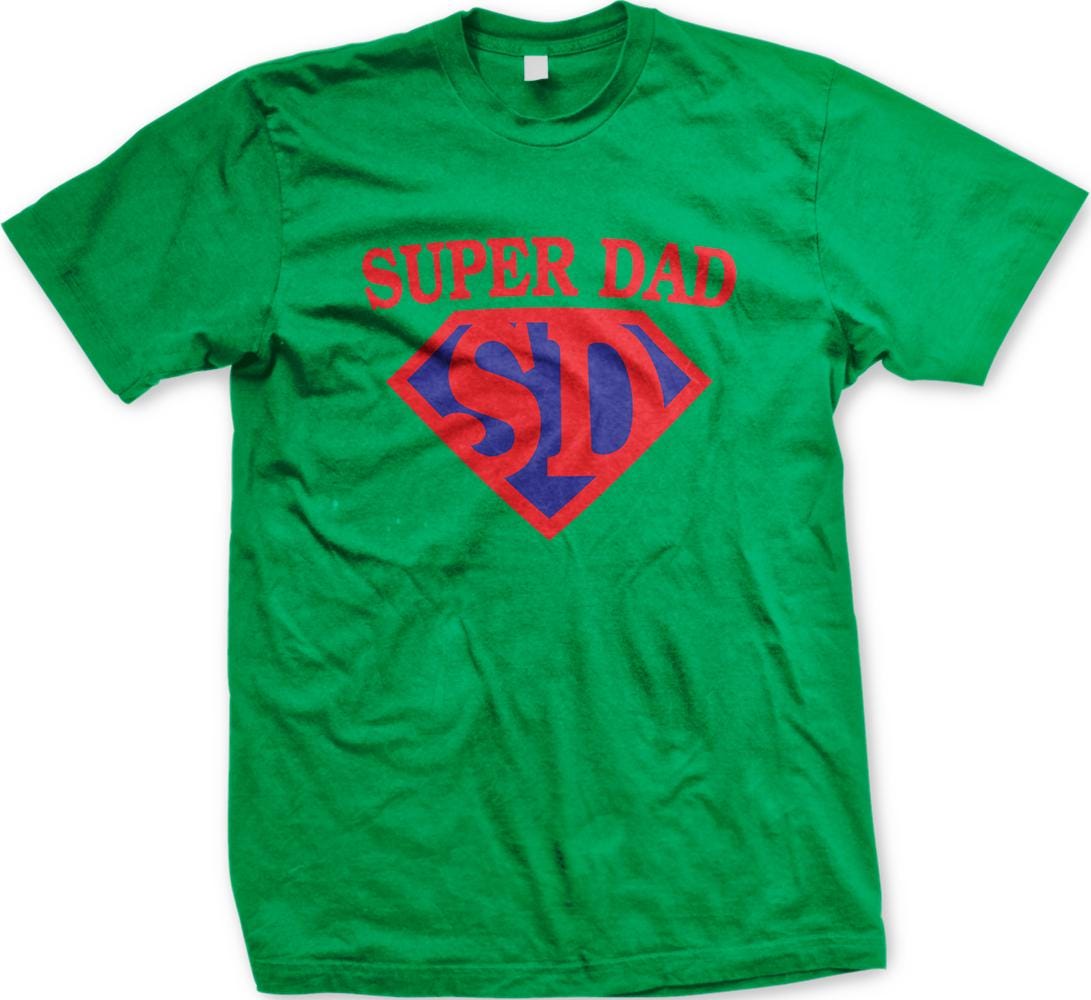 A green t-shirt with the text "SUPER DAD SID" printed on it in red and blue colors.