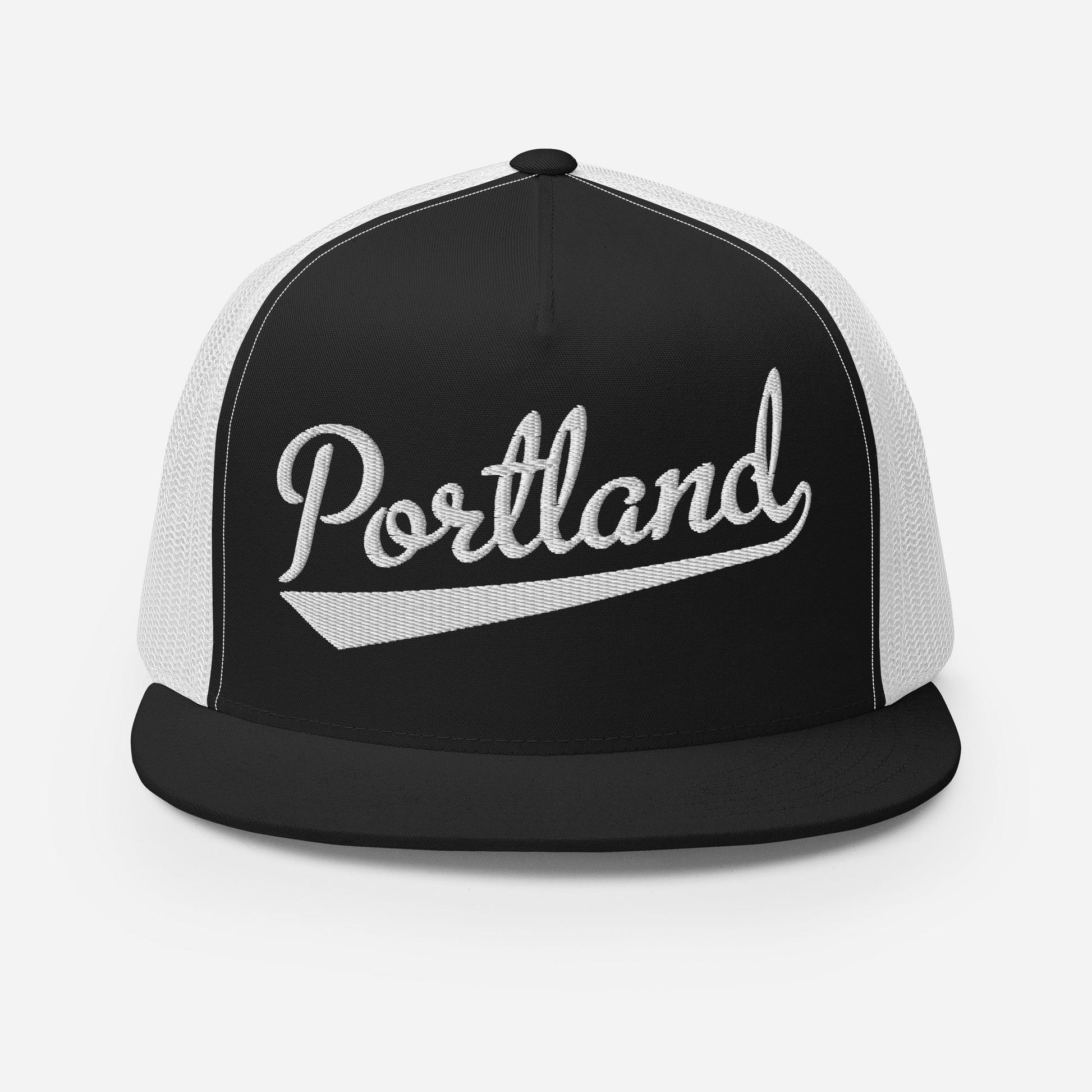 A black and white baseball cap with the word "Portland" printed on it.