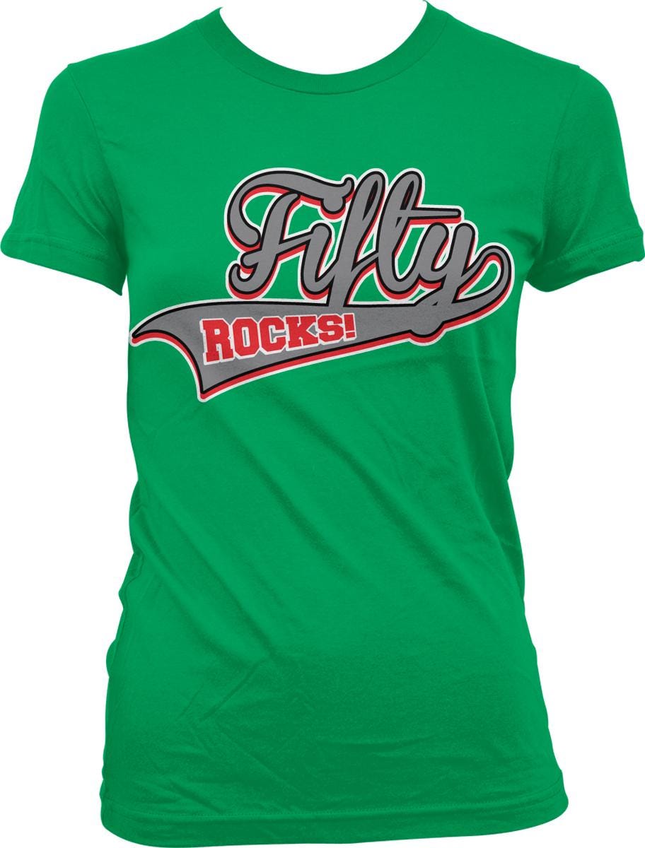 A green t-shirt with the text "Fifty Rocks!" printed on it.