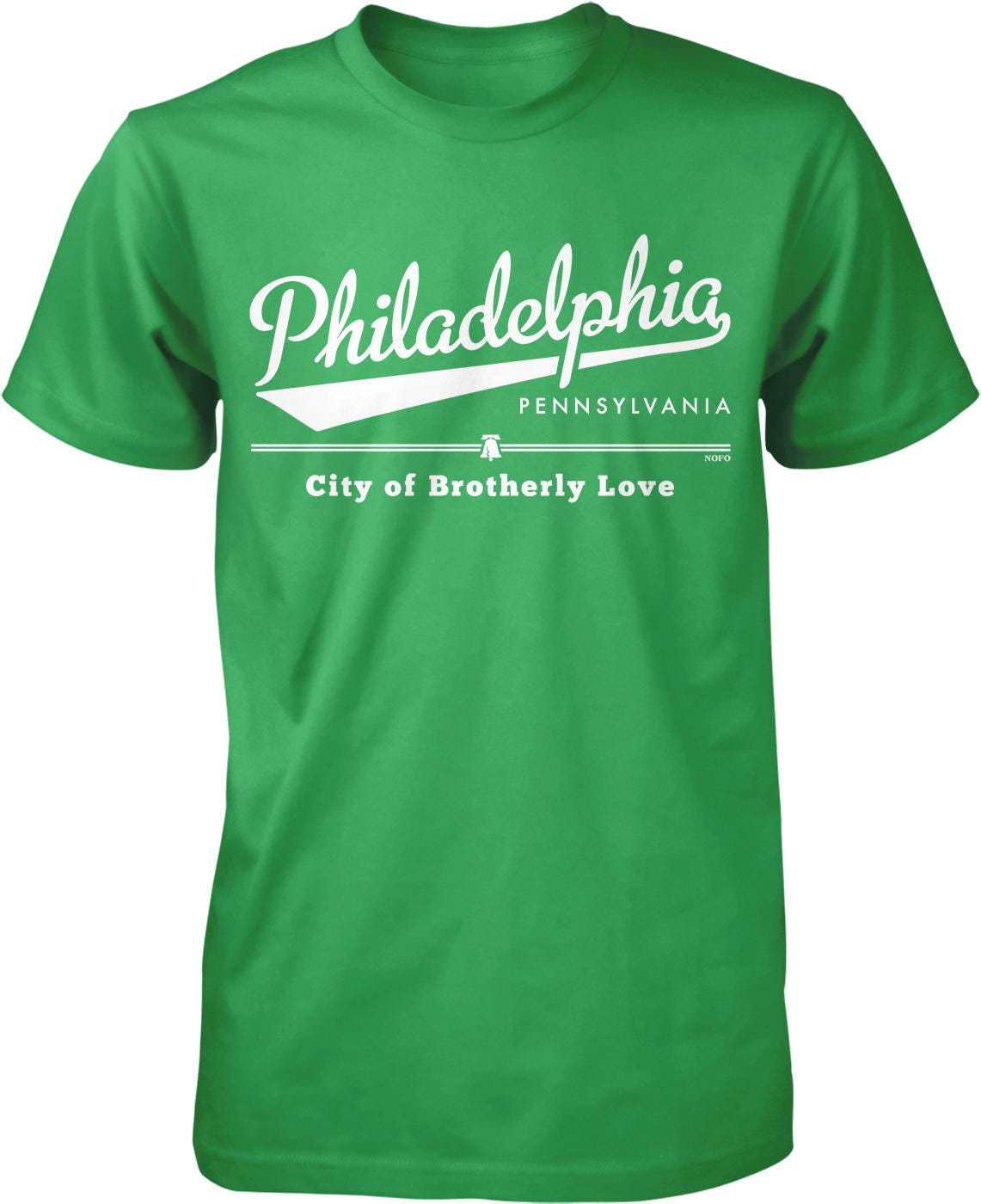 A green t-shirt with white text and graphics printed on it.