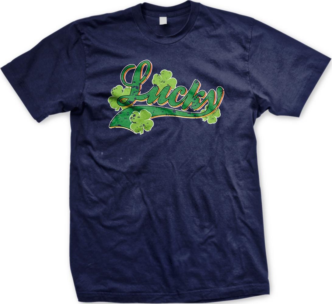 A navy blue t-shirt with a graphic design featuring the word "Lucky" and four shamrocks.