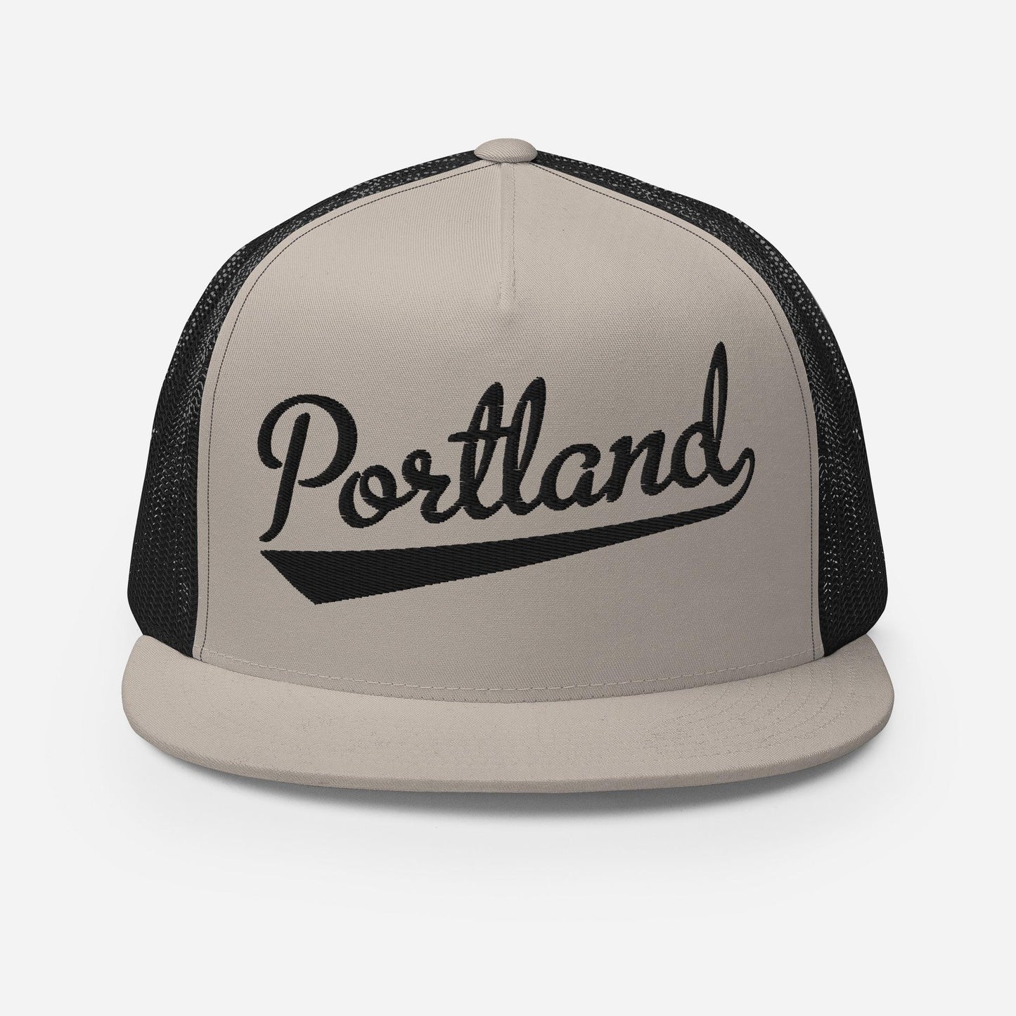 A beige baseball cap with the word "Portland" printed on it in a stylized font.