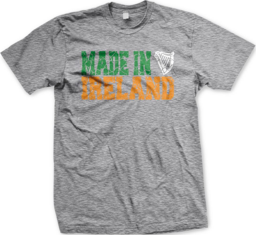 A grey t-shirt with the text "MADE IN IRELAND" printed on it in orange and green colors.