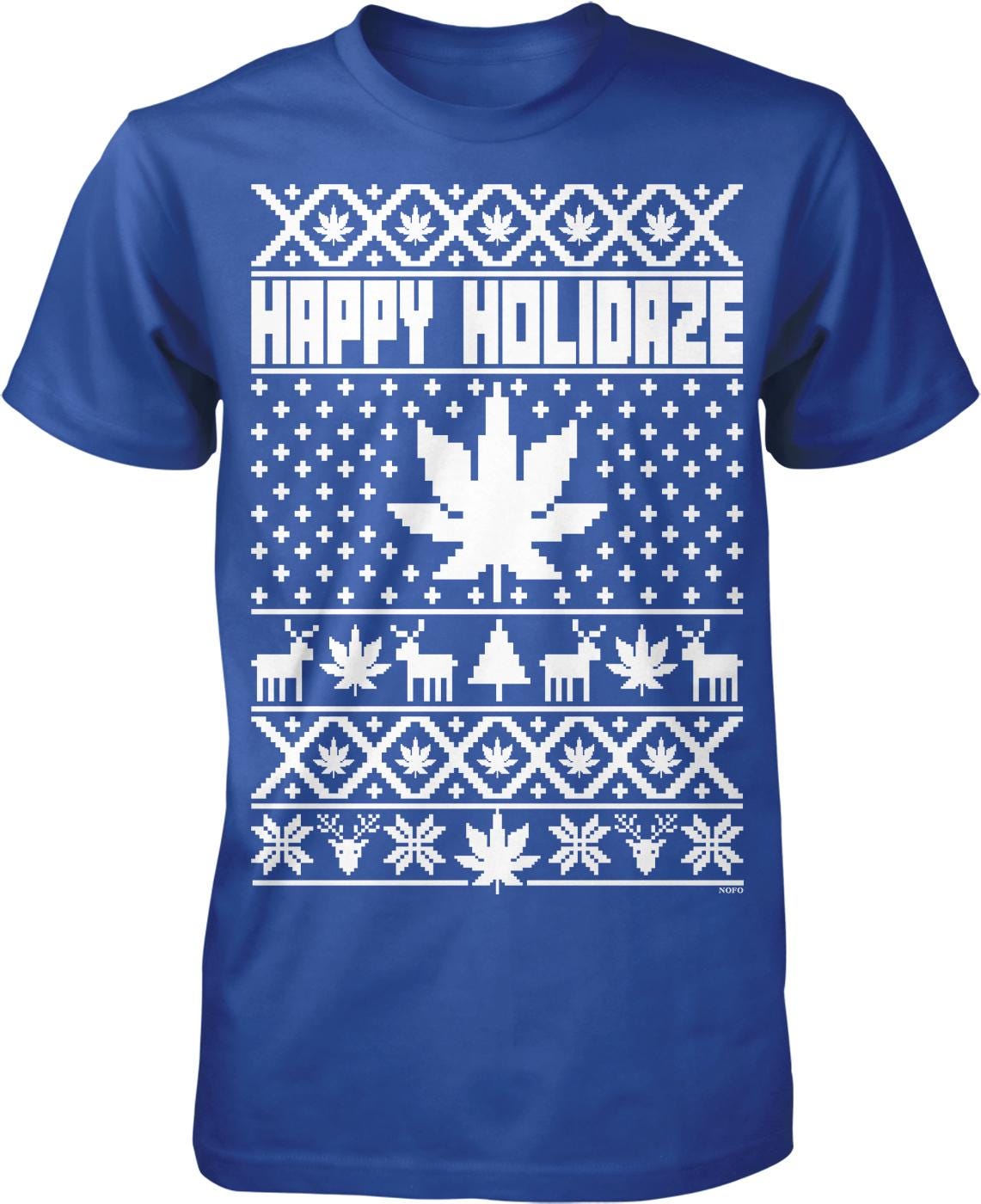 A blue t-shirt with a white Christmas-themed design. The design includes a snowflake pattern, a Christmas tree, and various other holiday-related elements. The text "HAPPY HOLIDAZE" is prominently displayed across the shirt.