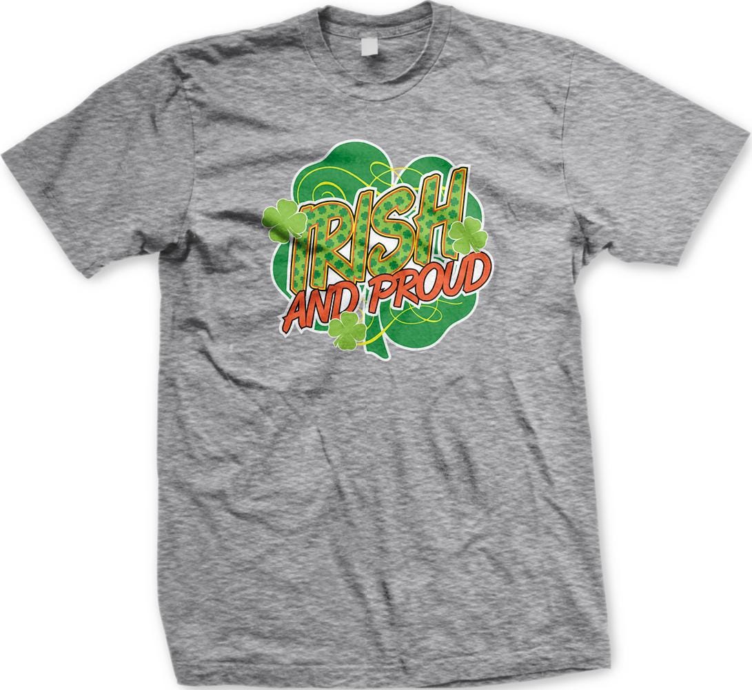 A grey t-shirt with a graphic design featuring the text "IRISH AND PROUD" surrounded by a shamrock and clovers.