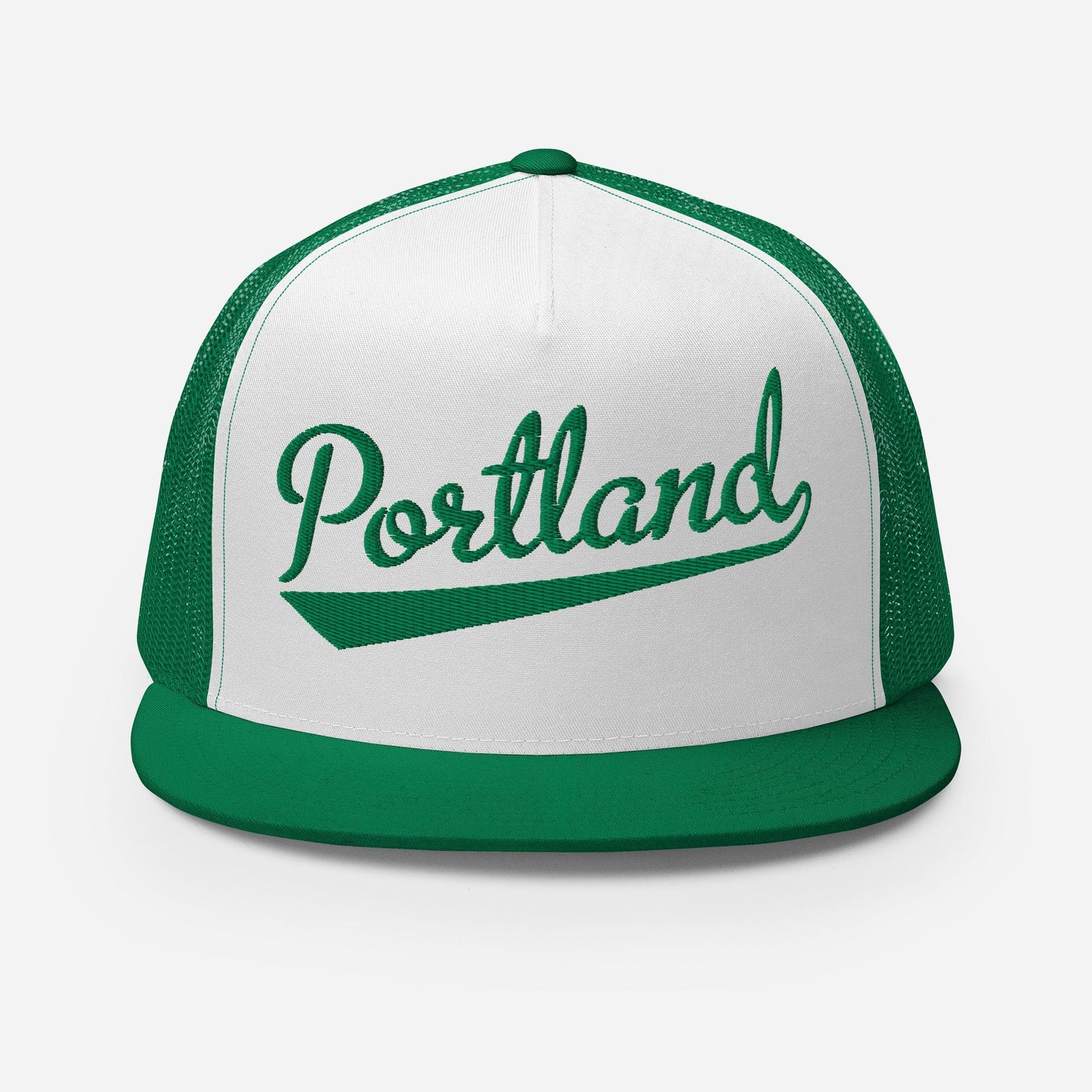 A green and white baseball cap with the word "Portland" printed on it.