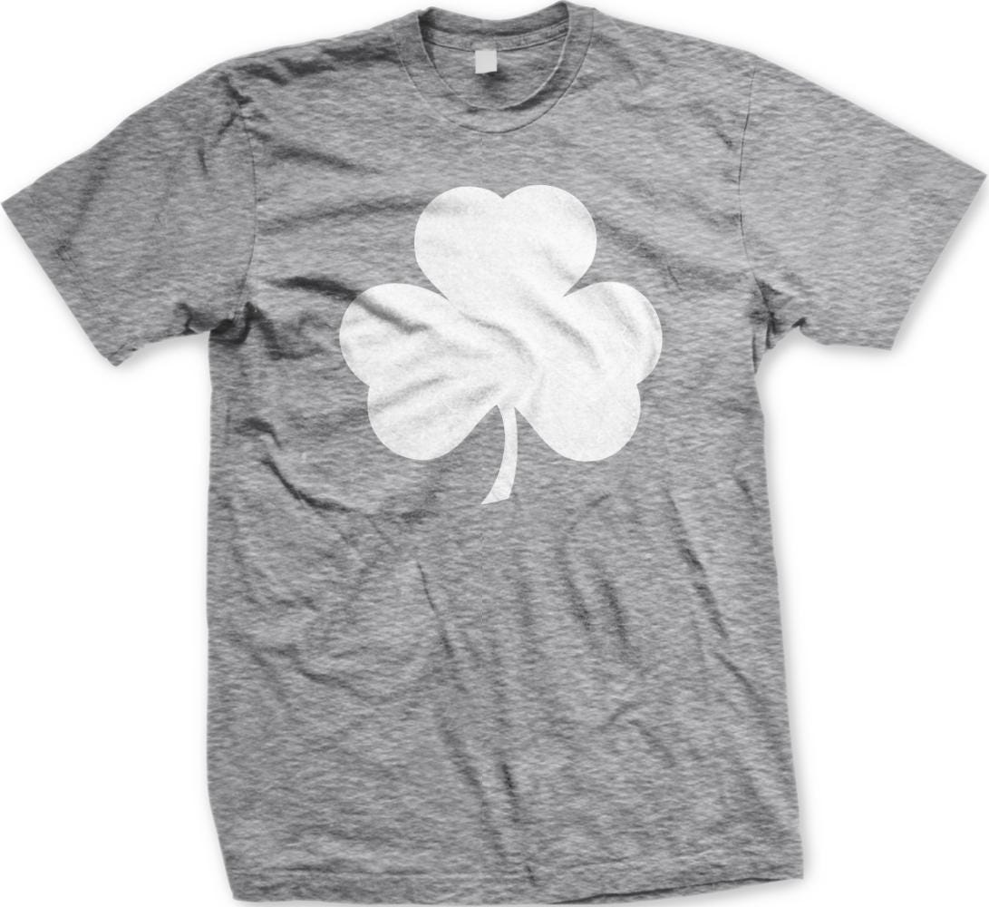 A gray t-shirt with a white shamrock graphic printed on it.