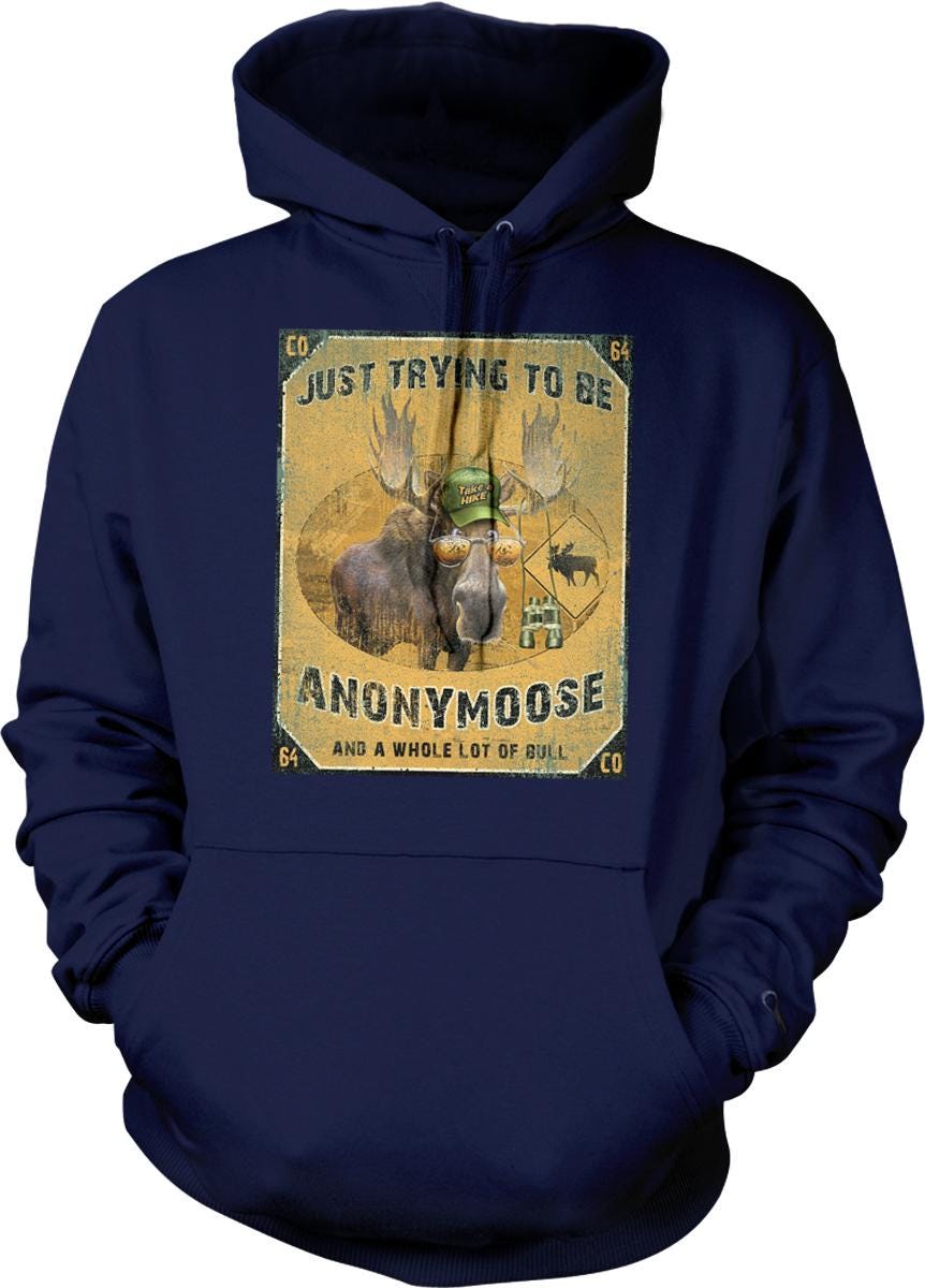 A navy blue hoodie with a graphic design featuring a moose wearing a hat and the text "Just trying to be ANONYMOOSE and a whole lot of bull".