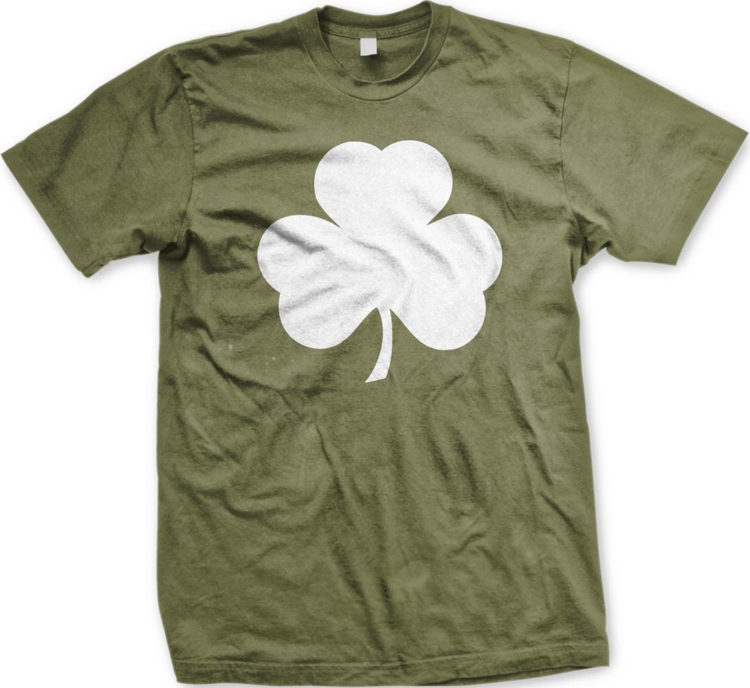 A green t-shirt with a white shamrock graphic printed on it.