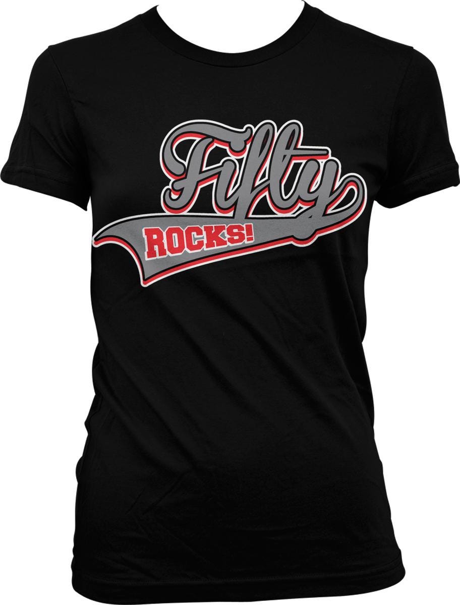 A black t-shirt with a graphic design featuring the text "Fifty Rocks!" in a stylized font.