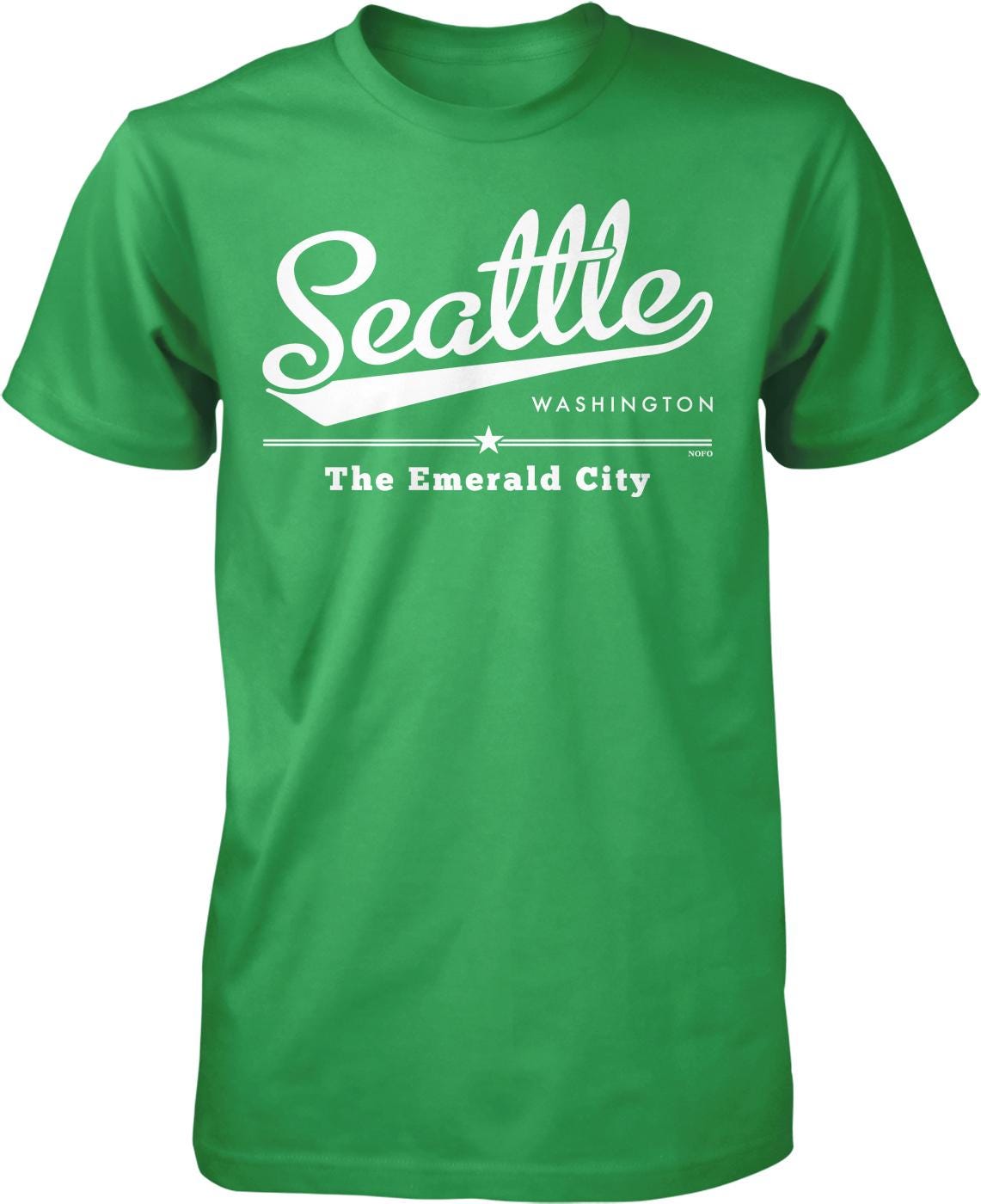 A green t-shirt with white text that says "Seattle Washington The Emerald City".