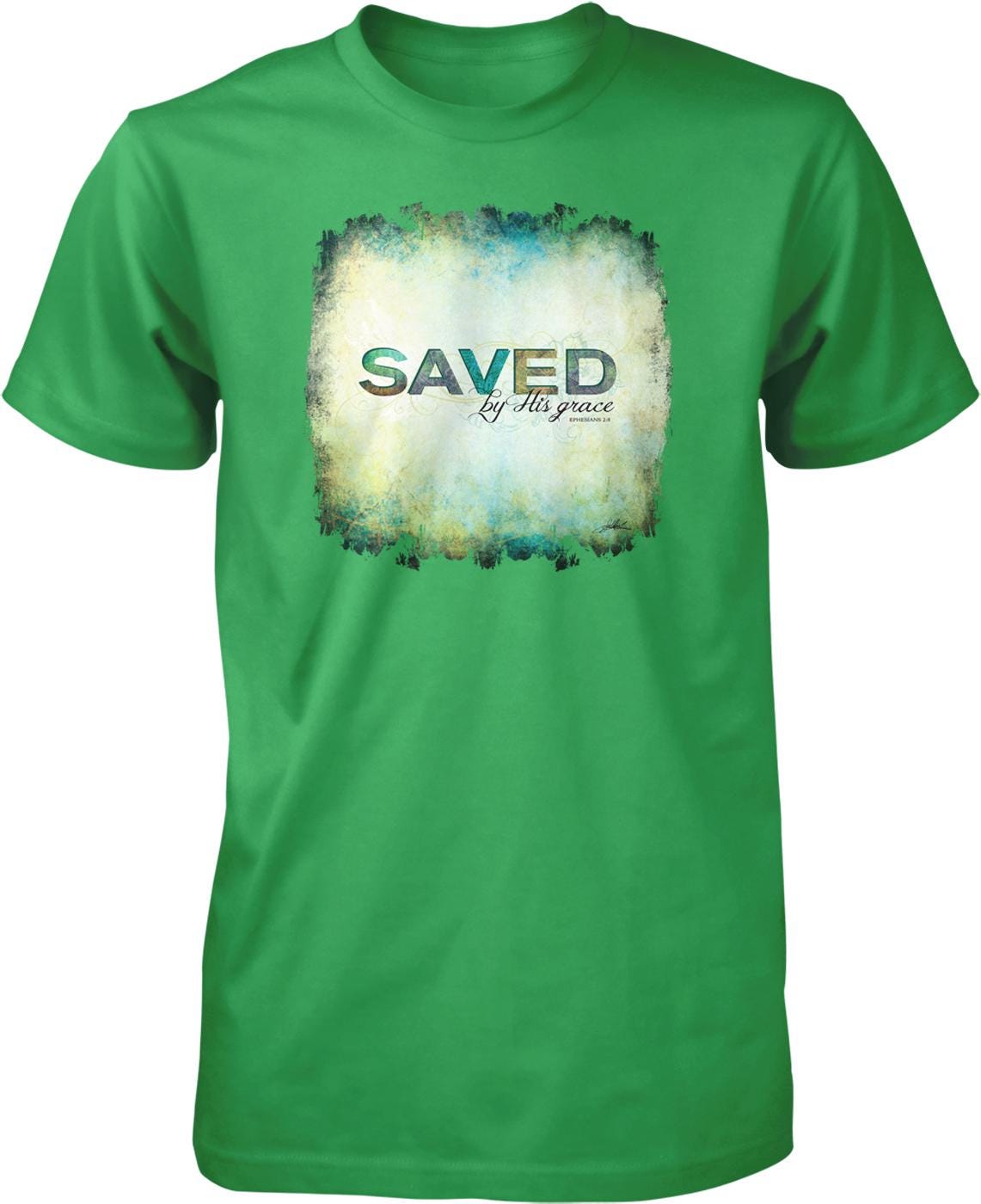 A green t-shirt with a graphic design featuring the text "SAVED by His grace" in a distressed, grunge-like style.
