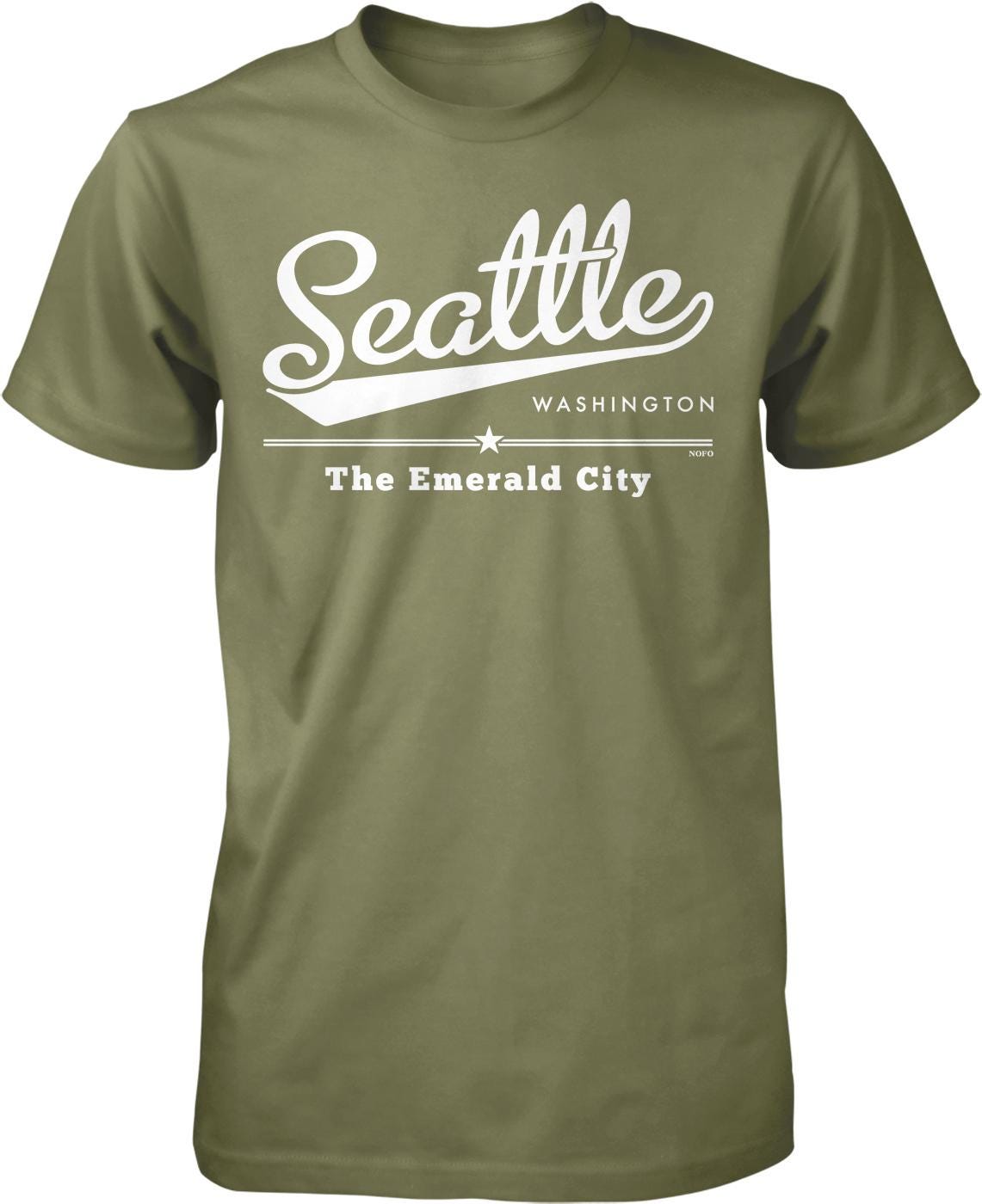 A green t-shirt with white text and graphics that say "Seattle Washington The Emerald City".