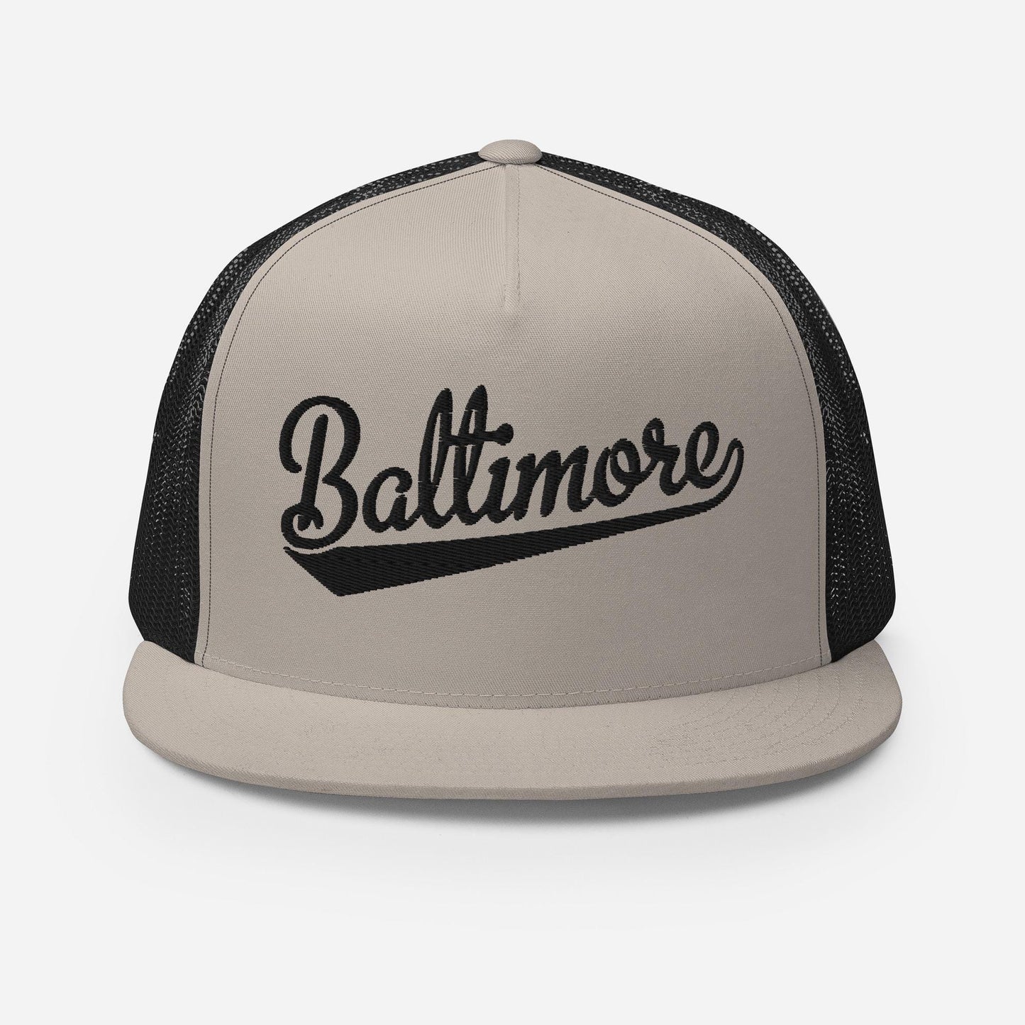 A beige baseball cap with the word "Baltimore" printed on it in a stylized font.