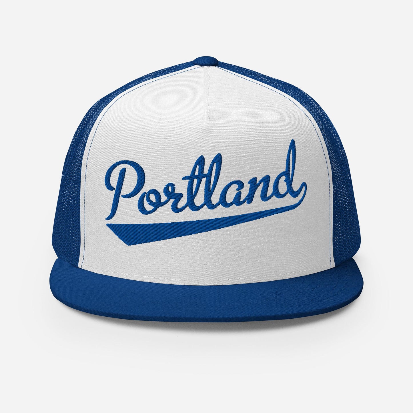 A white and blue baseball cap with the word "Portland" printed on it.