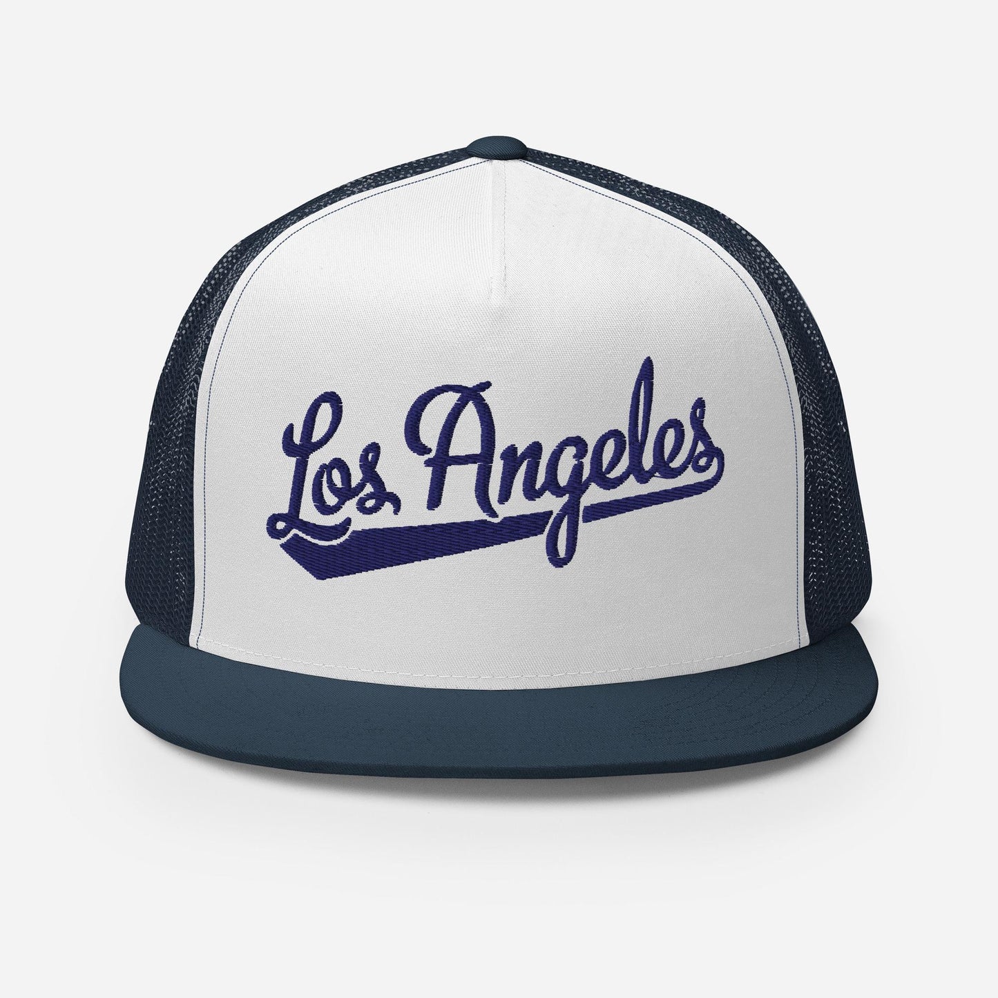 A white and navy blue baseball cap with the text "Los Angeles" printed on it.